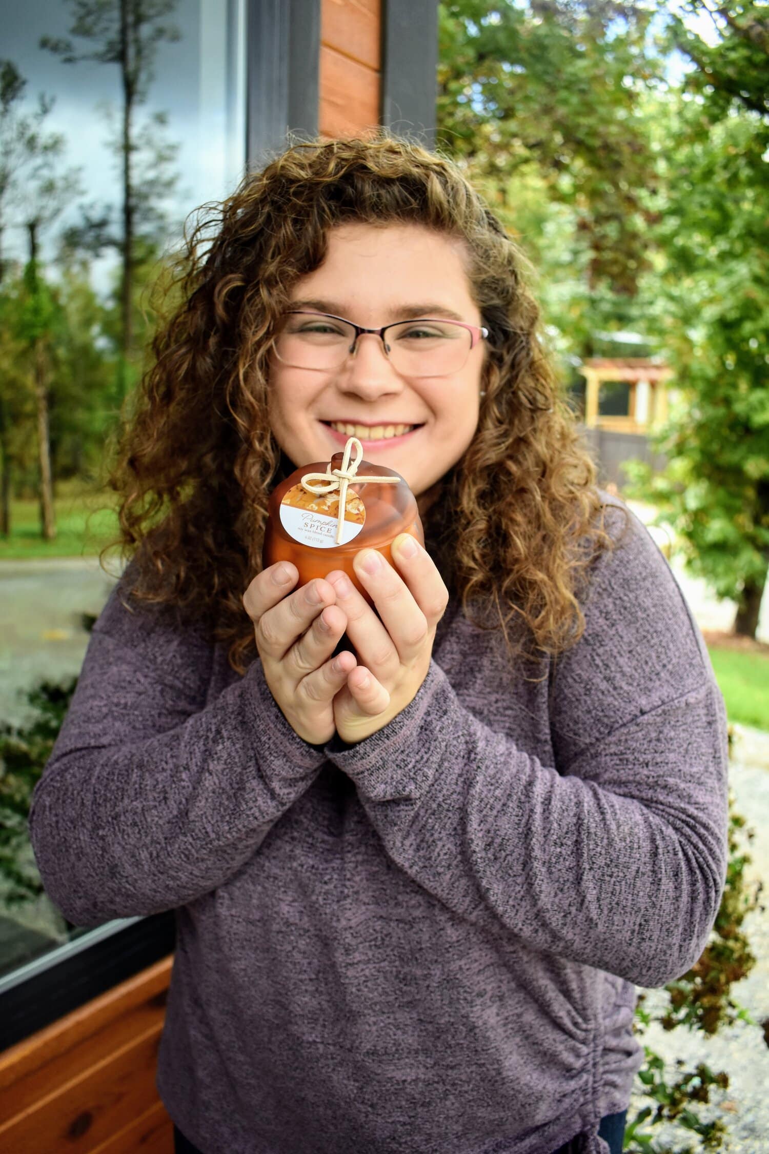 Next we found this pumpkin spice scented candle. Williamson displays the candle to show off its fitting design.