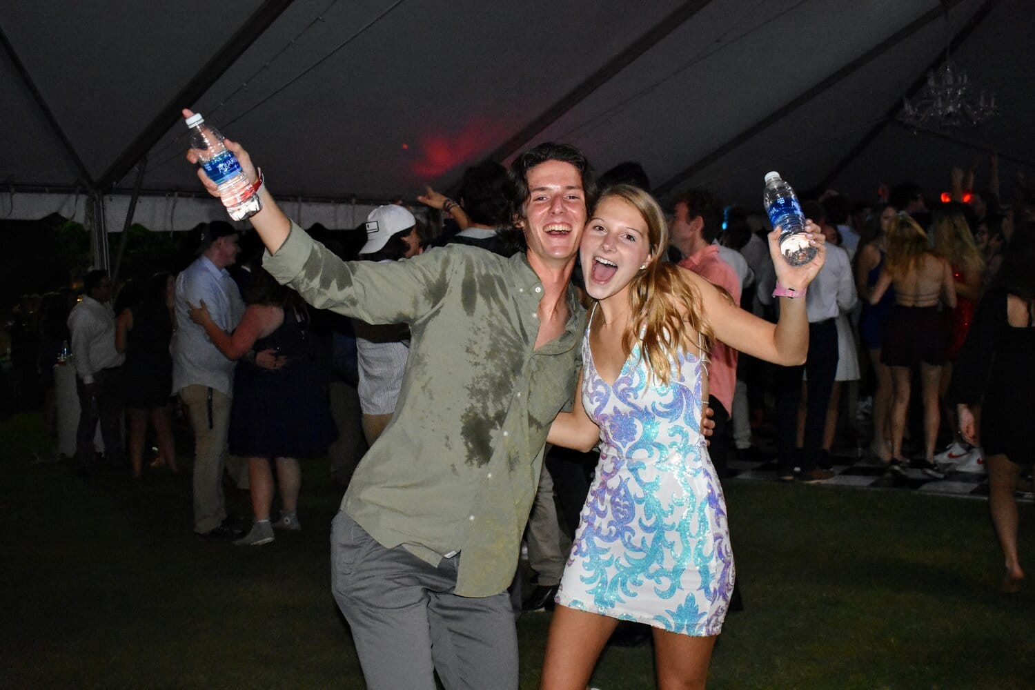 With the hot temperature under the dance tent, Caroline Goodson and Luke Petree, sophomores, are posing for the camera with their water bottles.