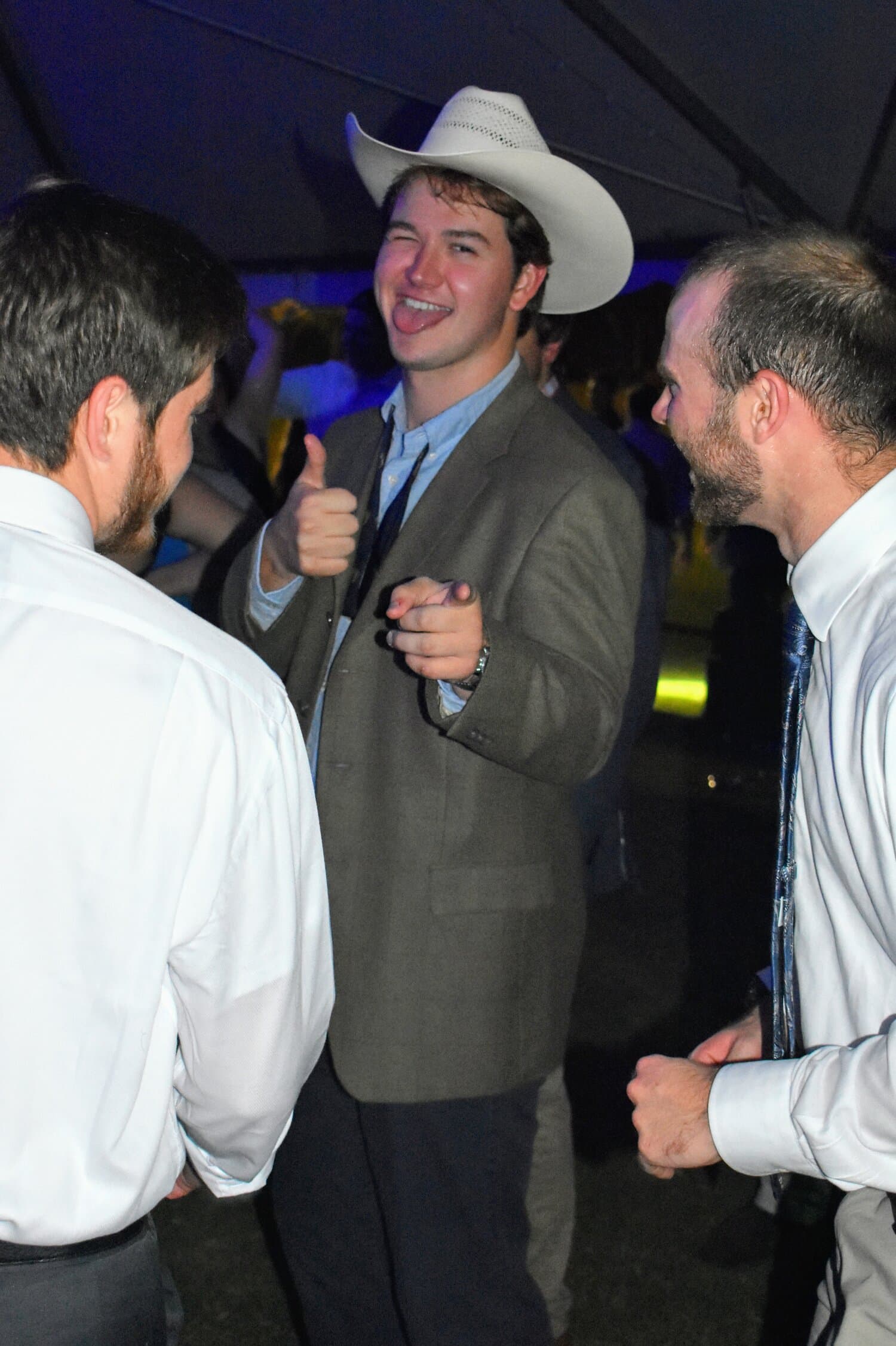 In a cowboy hat, Rhett Wilson, junior, points to the camera.