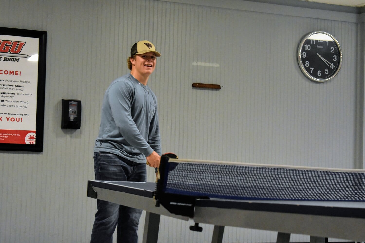 Riley McDonald, freshman, playing ping pong in the game room.
