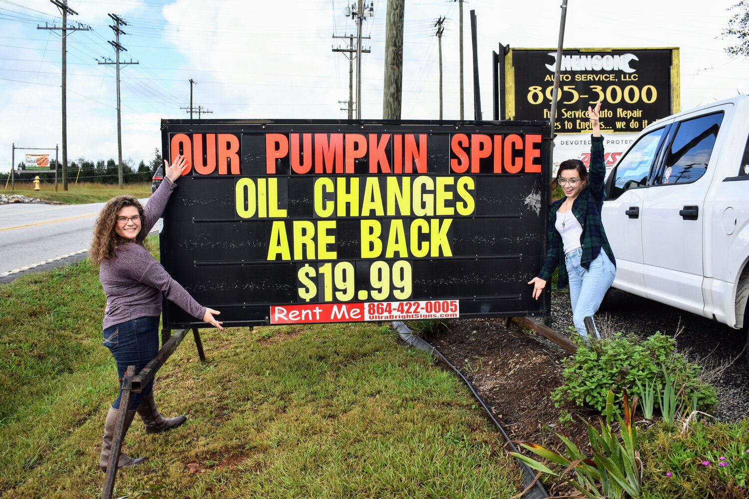 Yes, you read the sign correctly. You can even get a pumpkin spice oil change. Williamson and Jordan gather around the sign displayed by a local company that offers this unexpected repair.