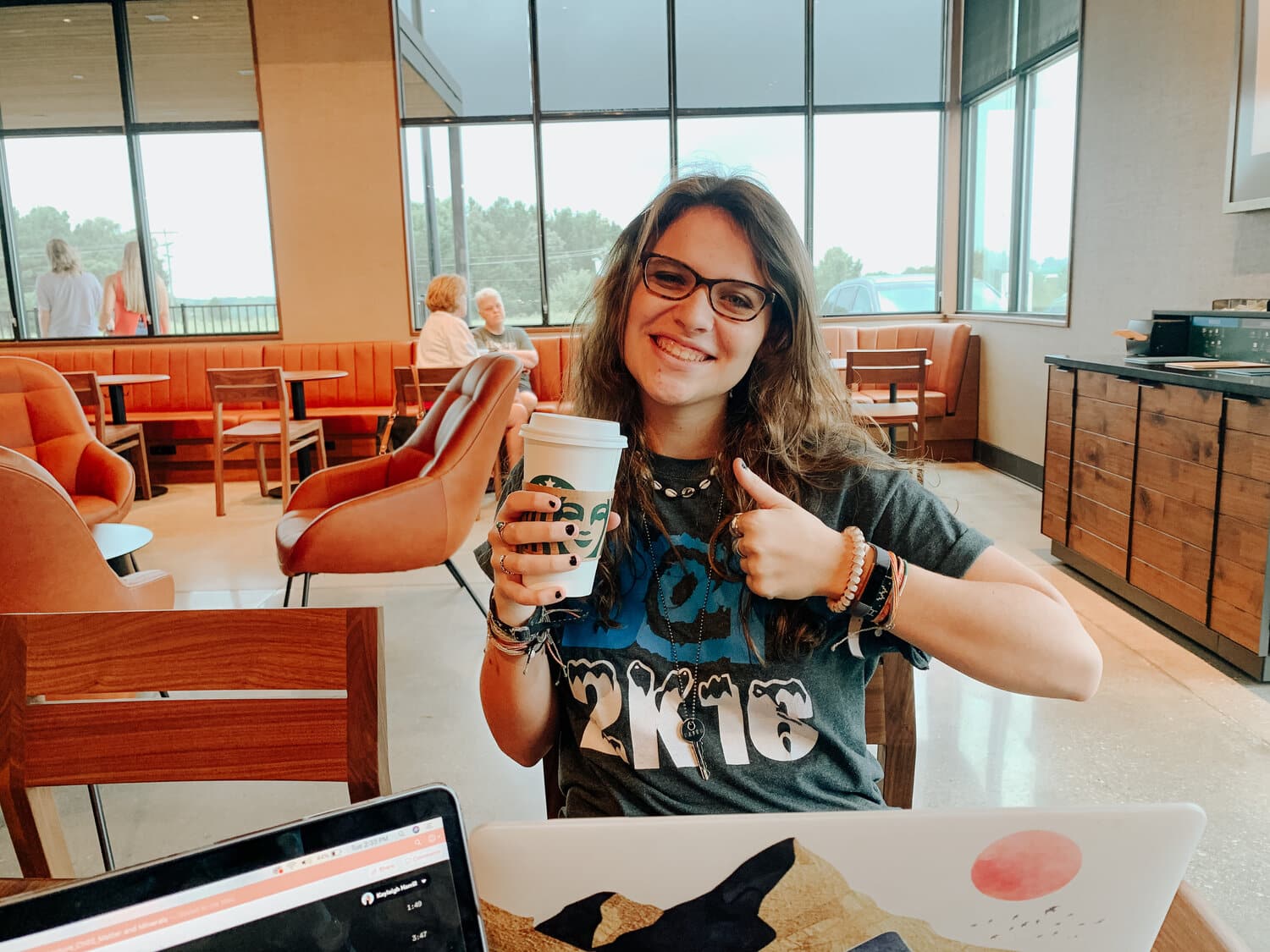 Junior Faith Acton gives a “thumbs up” to this new Starbucks location! Her caramel macchiato got her through all of her homework.