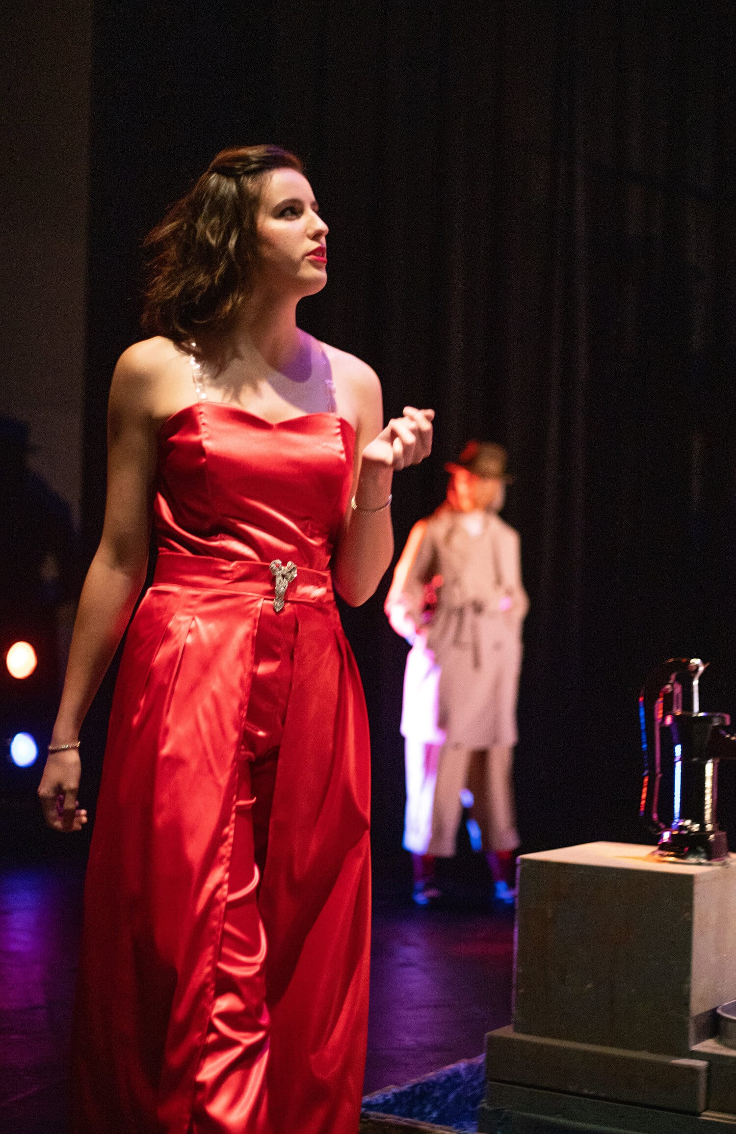 Abigail Dover, playing Lord of the Underworld, walks onto the main stage to talk to Eurydice.