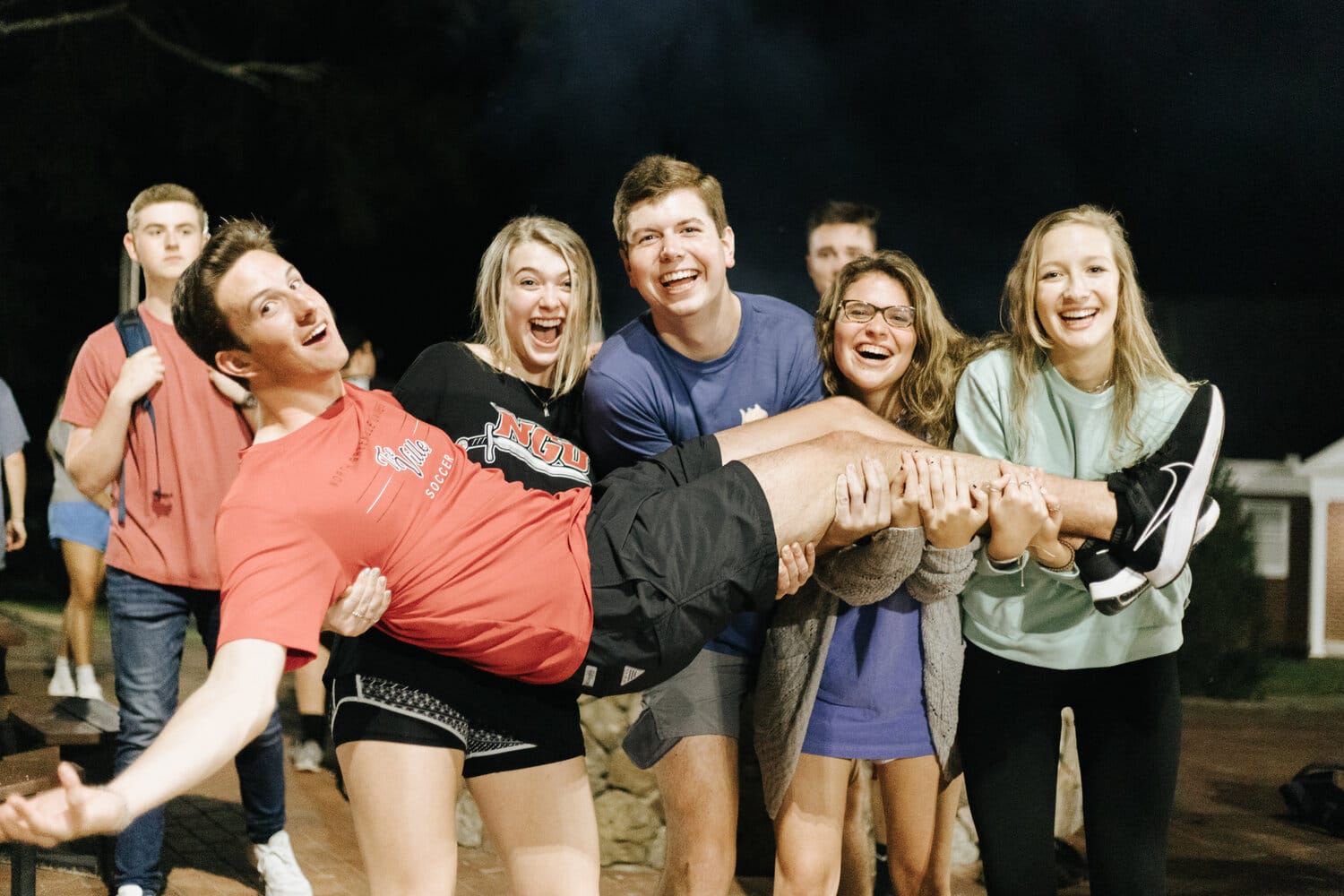 Friends (from left to right) Graham Lee, Winter Rose Bedenbaugh, Justin Brown, Faith Acton and Gia Zarella hanging around the fire pit at the opening ceremony.