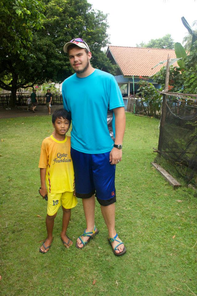  Nick takes a photo with a little boy he met during his time in Indonesia. 