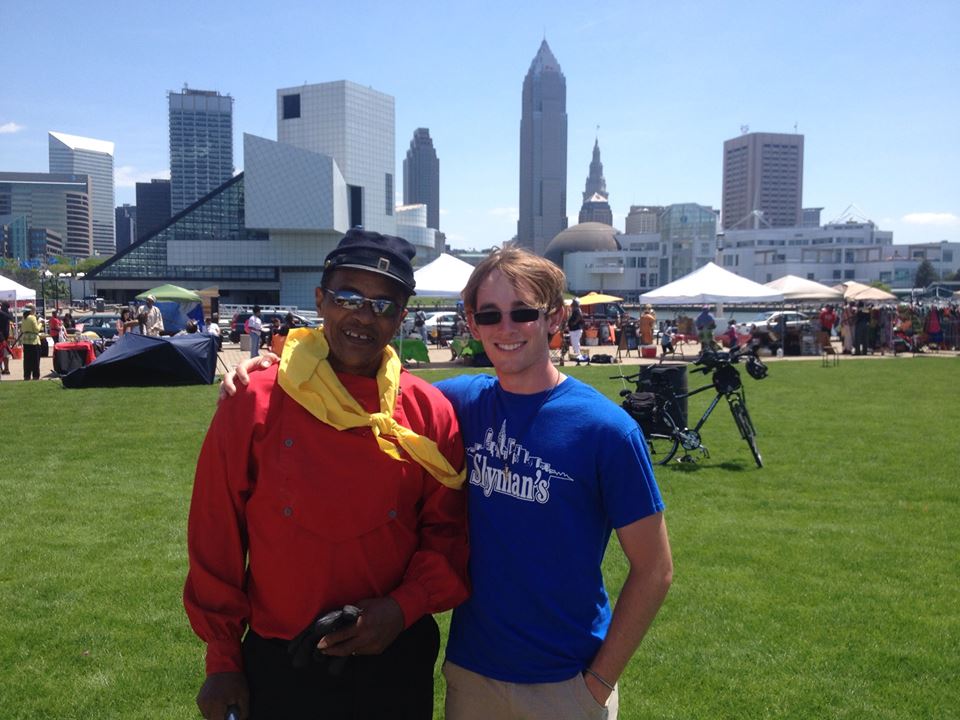  Aaron takes a photo with a man he met at the park. 