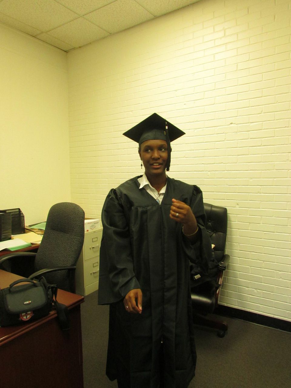 Photo by Danielle BatesFuture graduate Naomi King tries to remember which side the tassel goes on as she on cap and gown