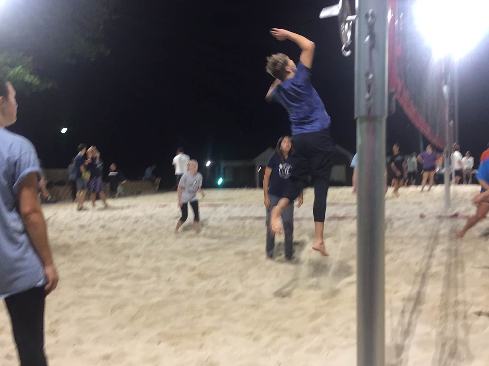 Connor Hash in mid air spikes the ball over the net to add points to the board.&nbsp;Photo By: Grant Moses