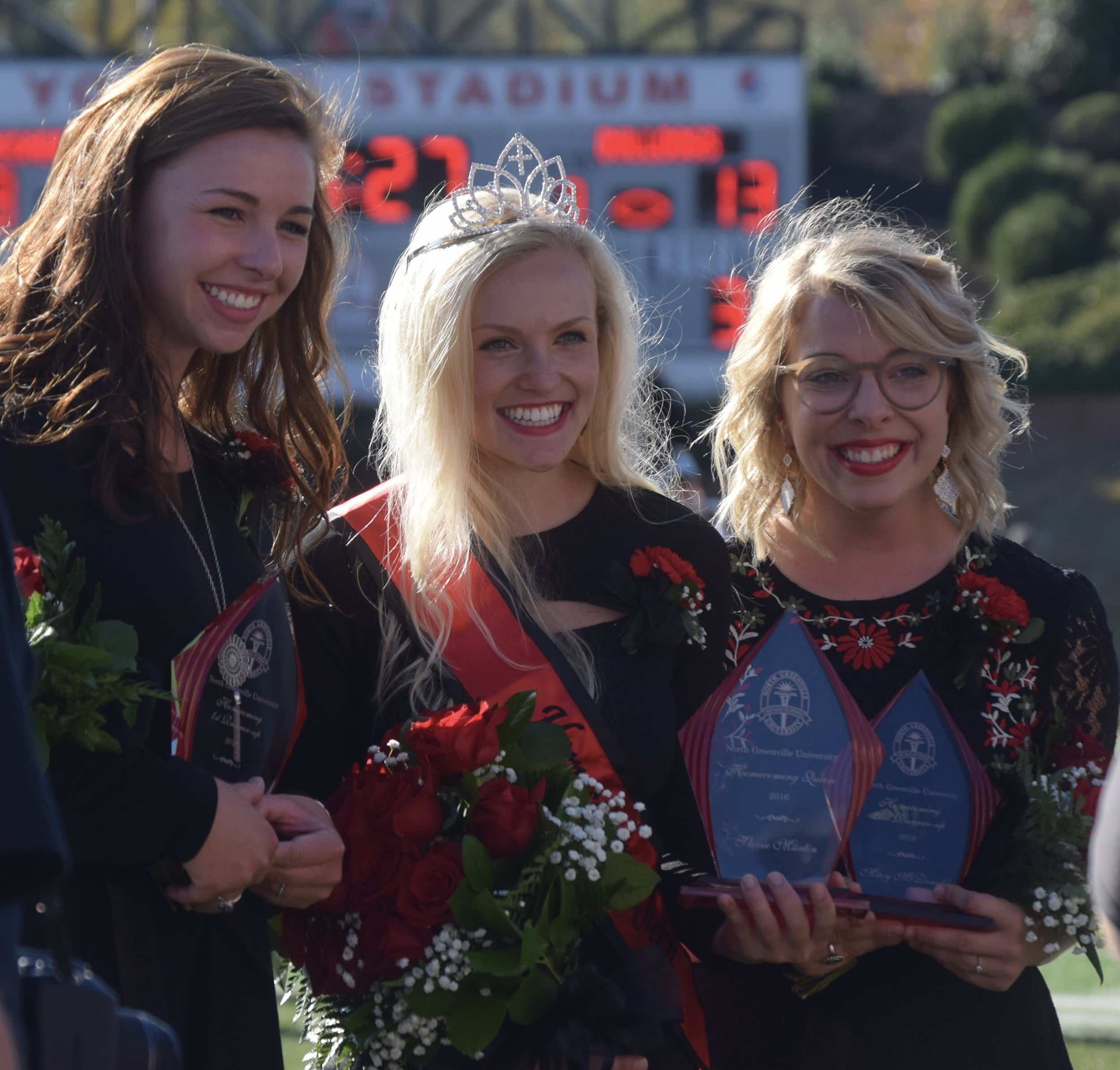 The Homecoming Queen poses with the first and second runners-up.