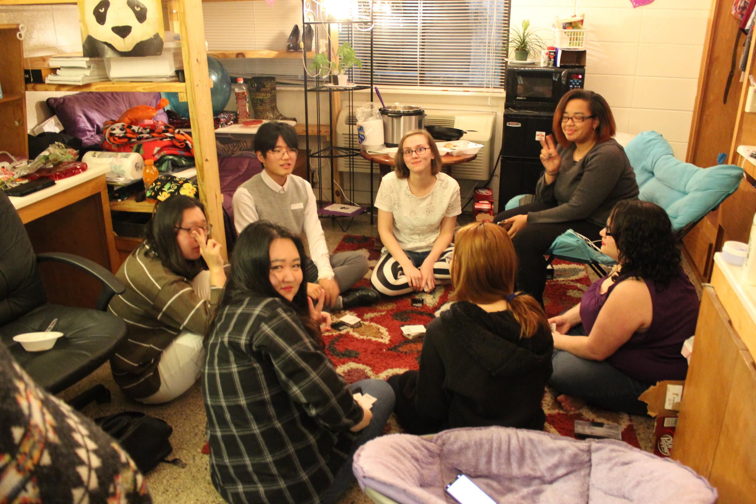 Nisa Navarro, an interdisciplinary English and communication major, Hannah Bate, a linguistics and English major, Ashia Davenport, a criminal justice and linguistics major and their guests Lily, Shawn, and Nancy enjoy the open dorms with a card game.