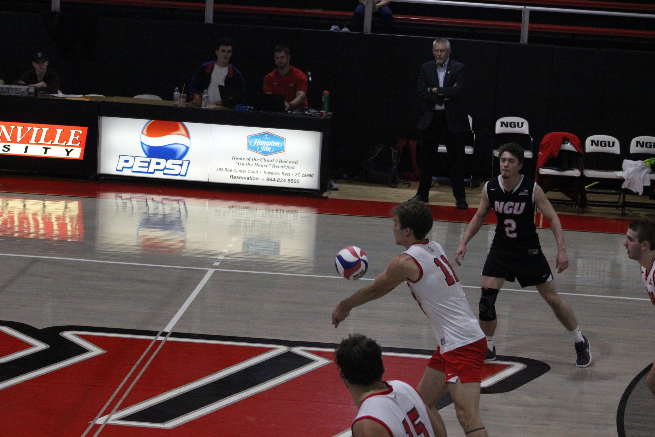 Number 11 Kyle Brandt retiring the ball back over the net.&nbsp;