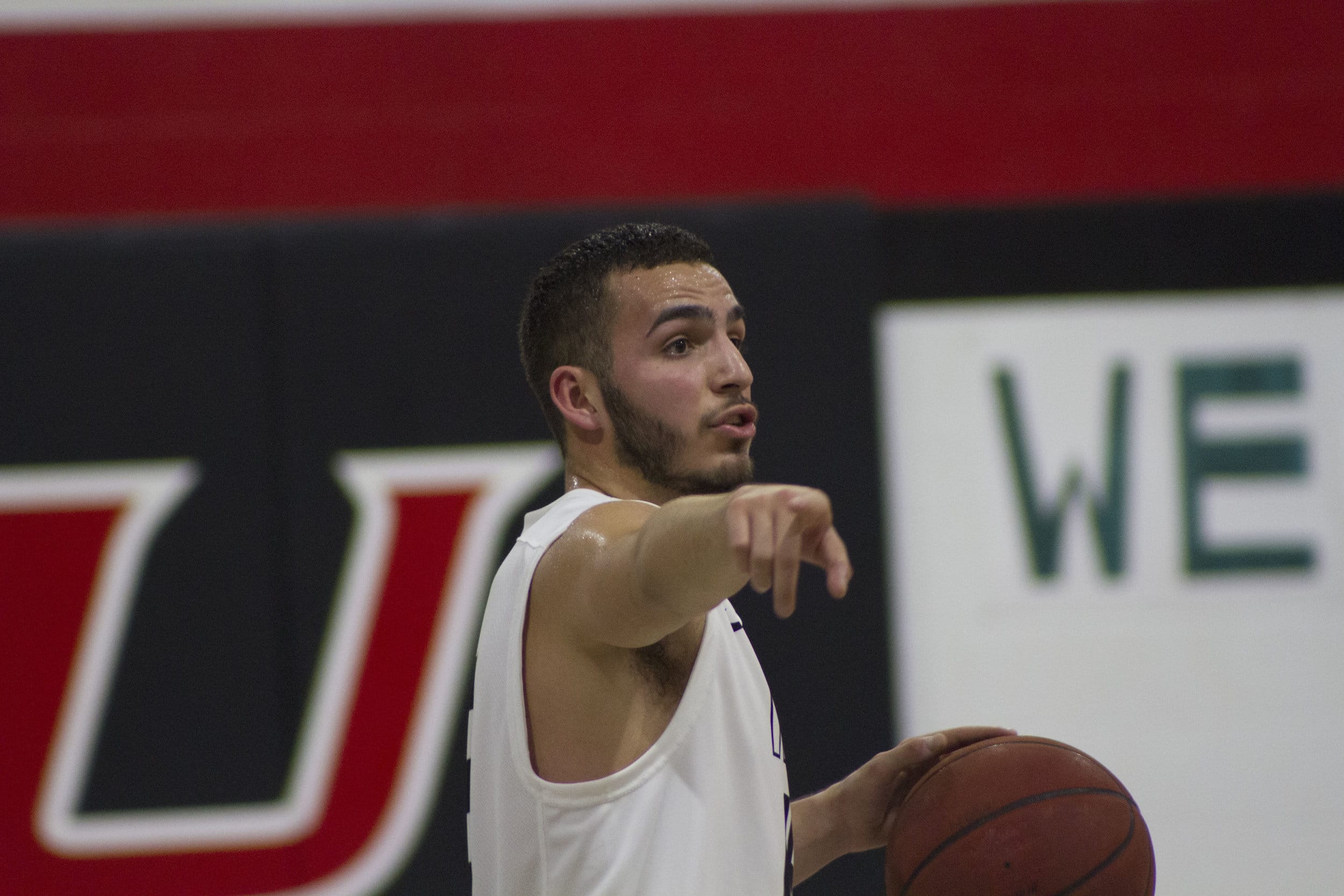 Point Guard, Miguel Cartagena, directs teammates to set up for an offensive possession. Photo credit: Triston Evans