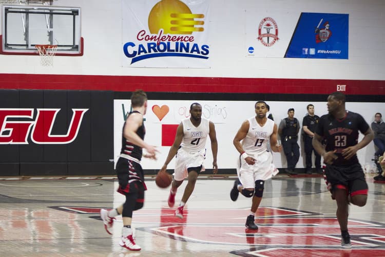 Justin Dotson (21)&nbsp;pushes the ball up the middle of the court in transition. Photo credit: Tristan Evans