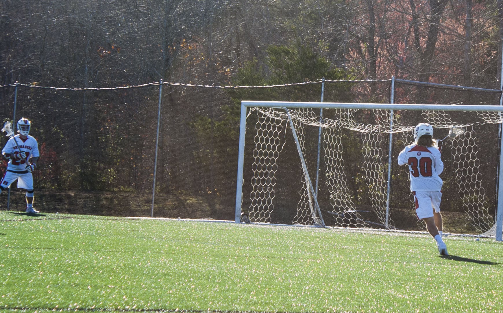 Ethan Landreth (30) passes to teammate Austin Dixon (23).