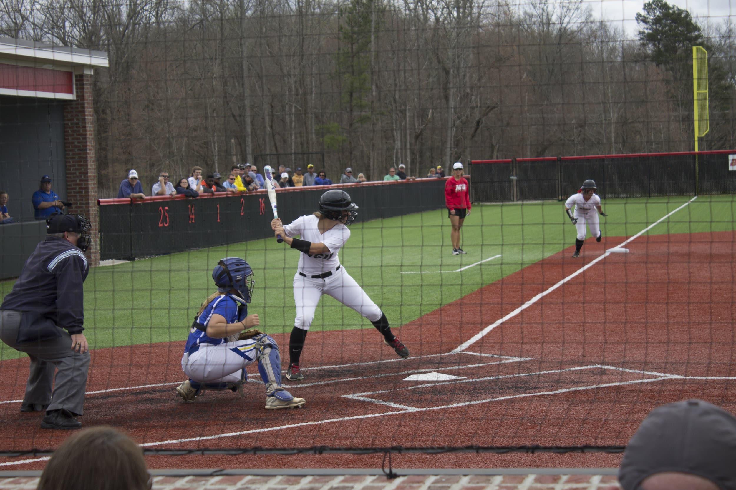 A North Greenville player looks to hit her teammate home during last Saturday's contest against Limestone.