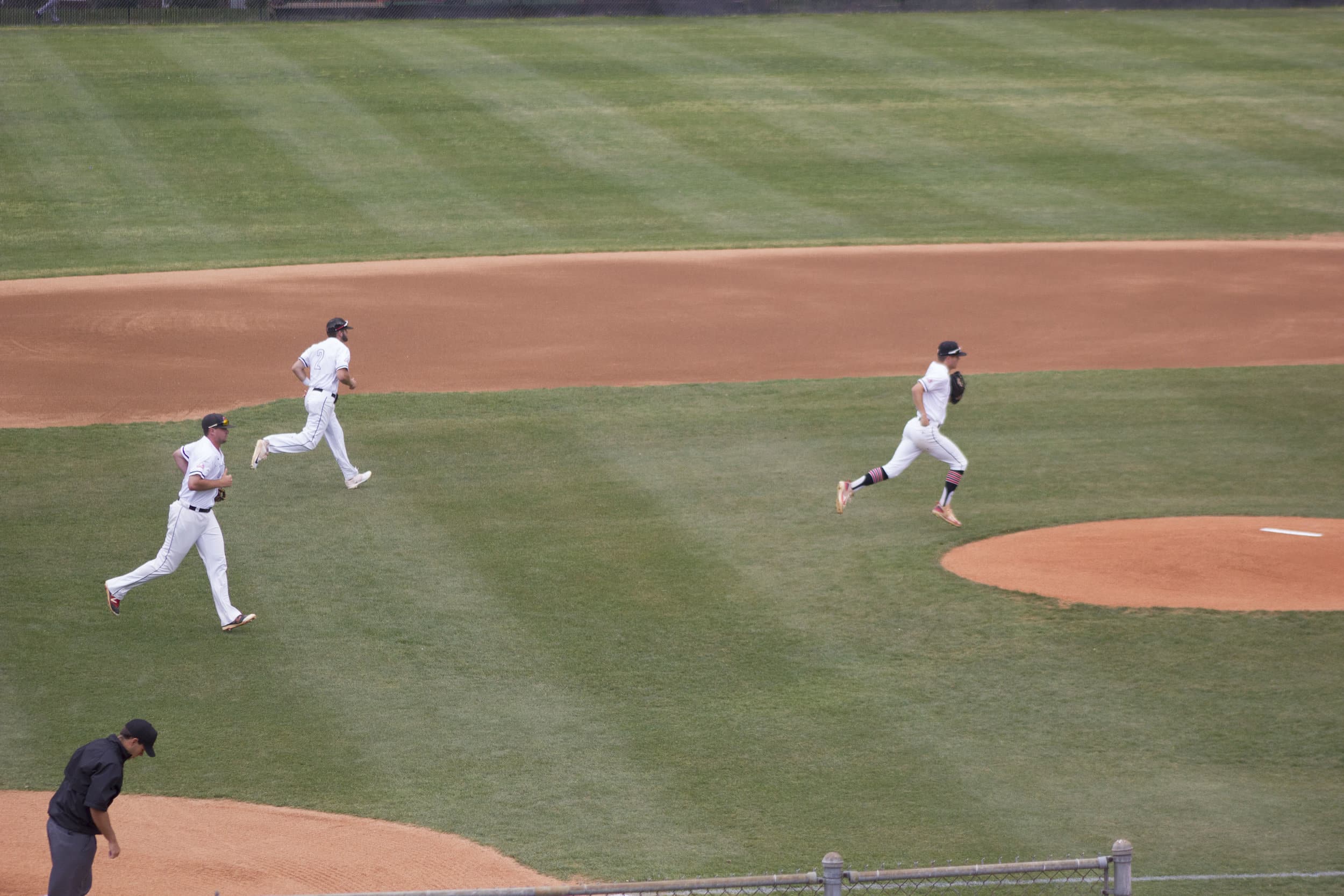 Three Crusaders take the field ready to hold the Pfeiffer Falcons on defense after a prolonged thunderstorm delay during Saturday's matchup at Ashmore Field