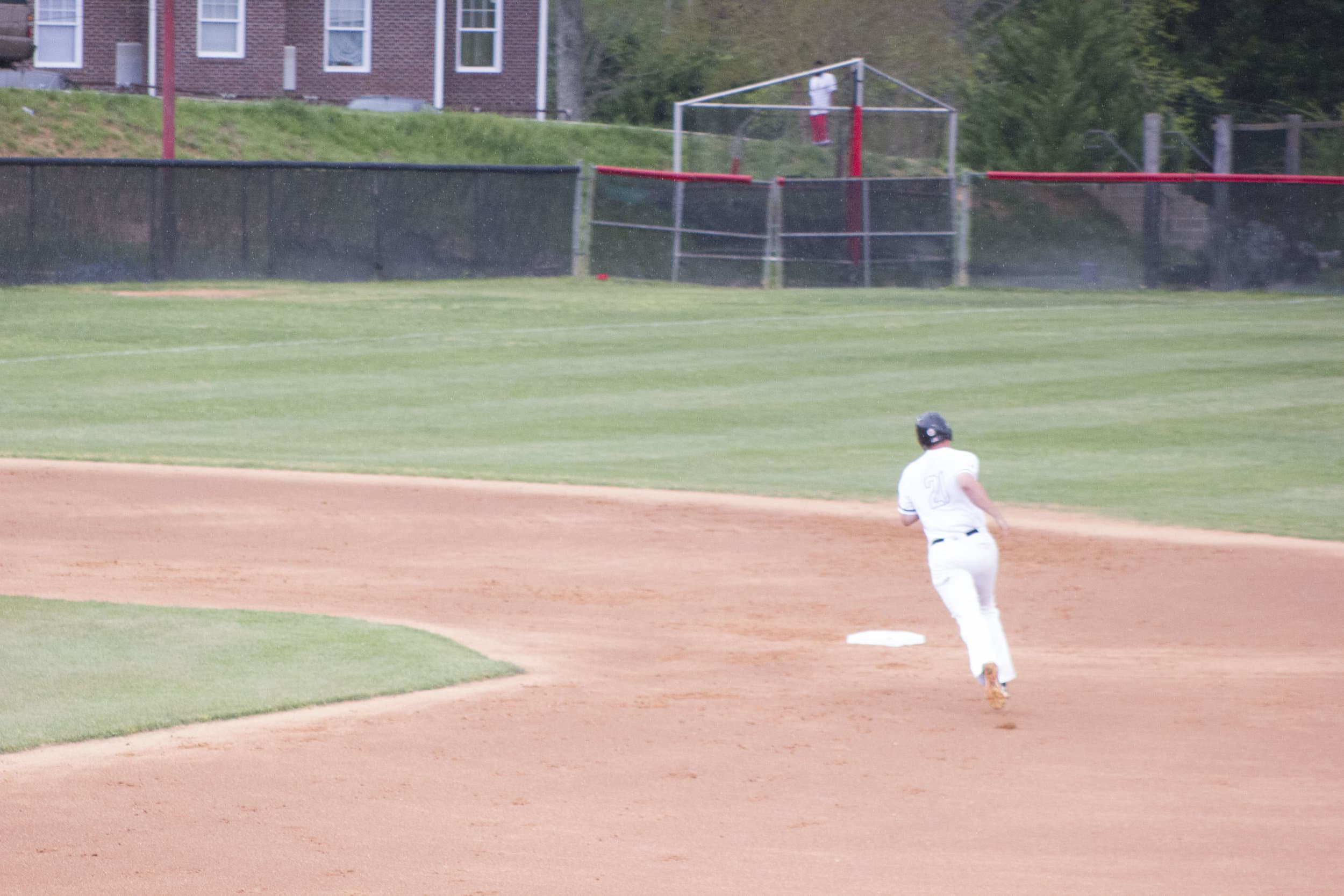 Nathaniel Maggio rounds second base after crushing a home run over midfield.