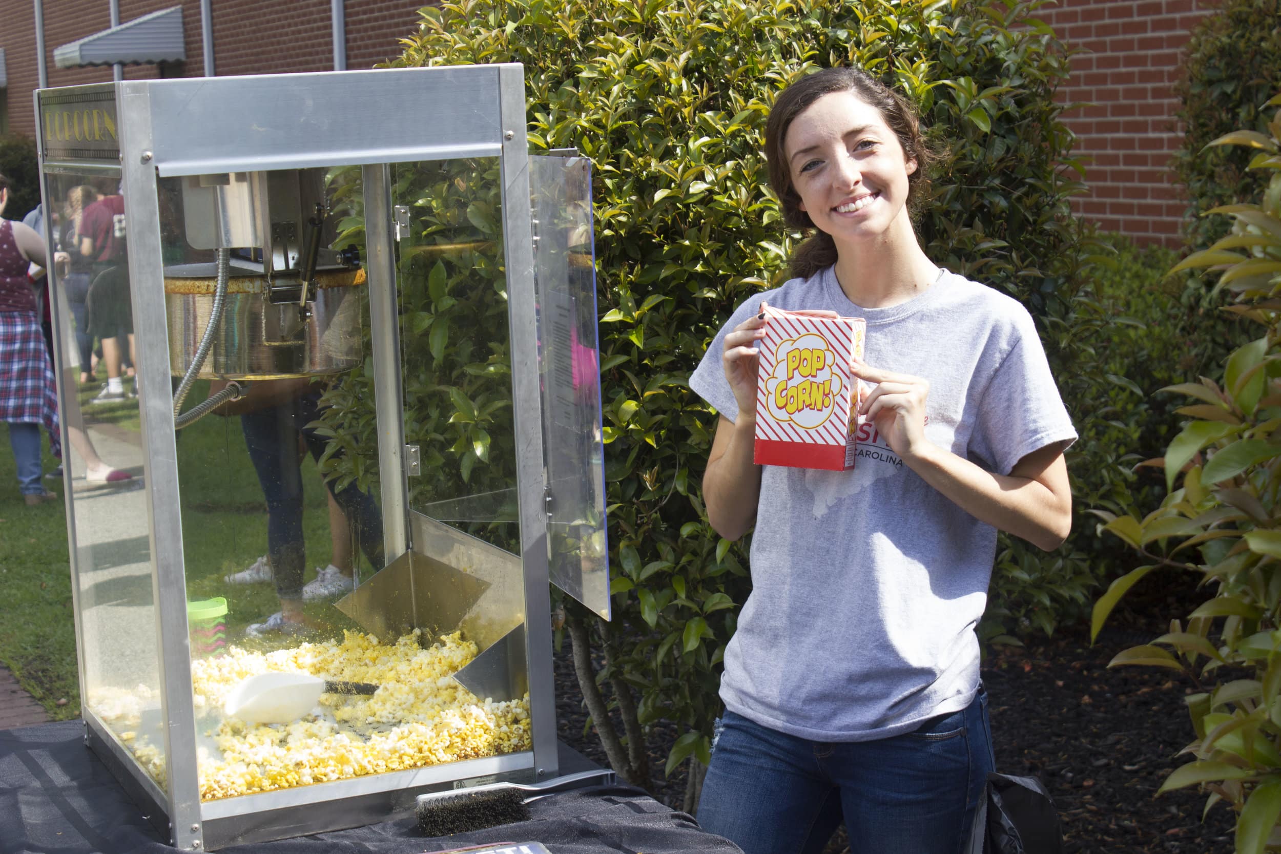 Bailey Pattson shows her excitement for the incoming freshmen class of 2021 by serving them popcorn.