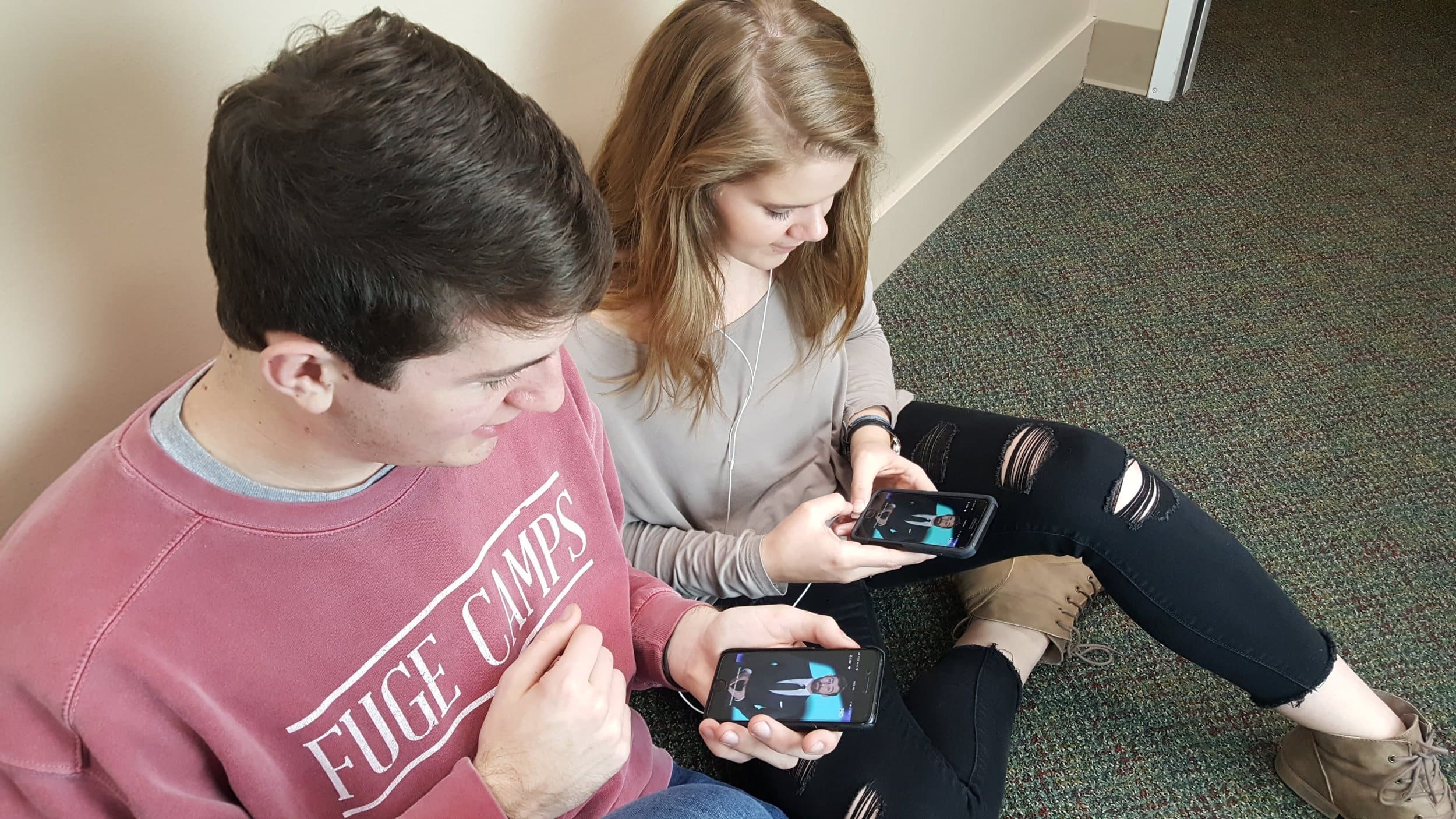 Juniors Clay Webb and Harley Watkins watching HQ Trivia host Scott Rogowsky explain the rules of the game.