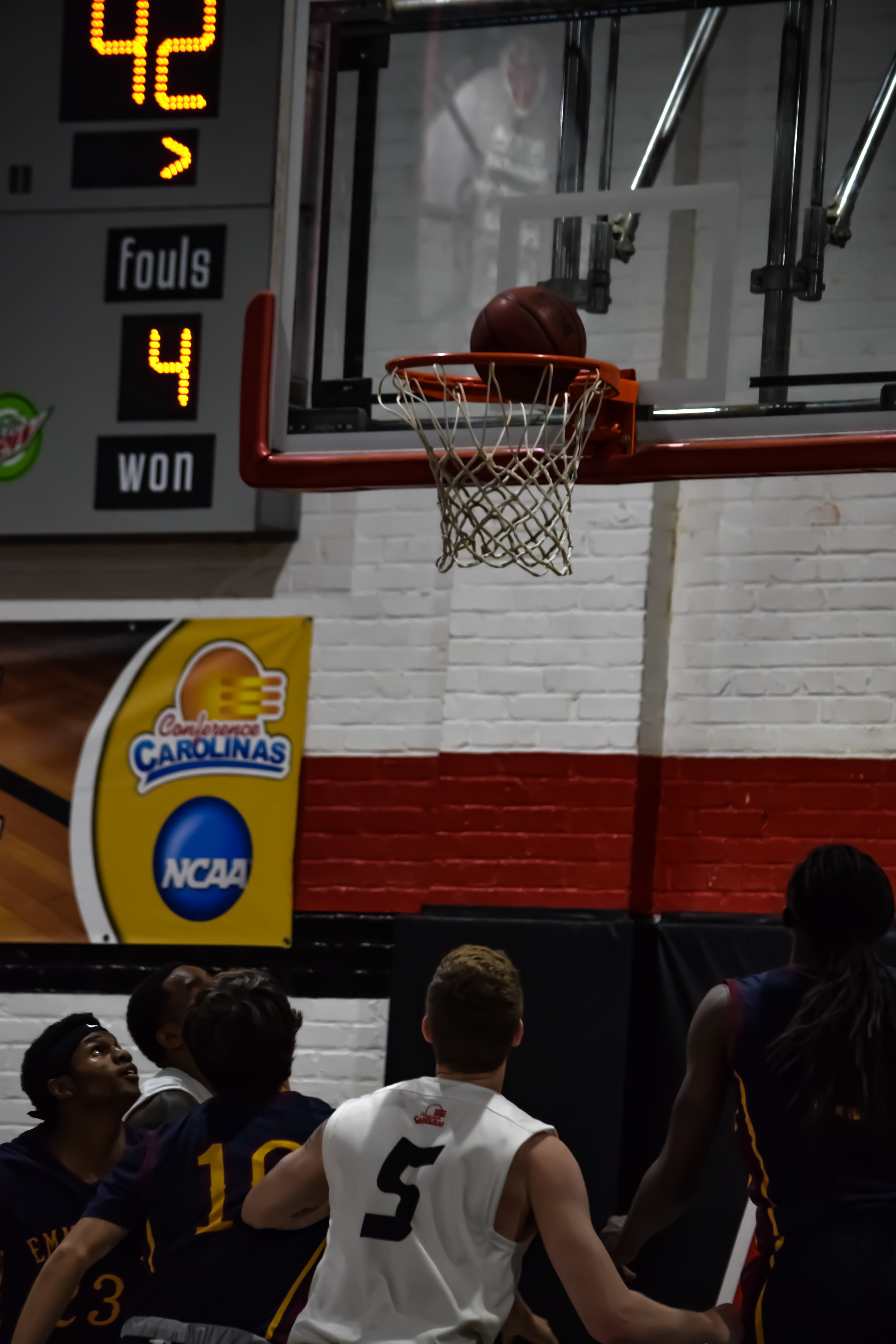 The anticipation rises as both teams wait to see if the ball will go through, including NGUs # 5 Matt Moore and Emmanuel College's #23 Kendrick Colvin, #10 Derek Vandiver and #2 Kurtis Robinson.