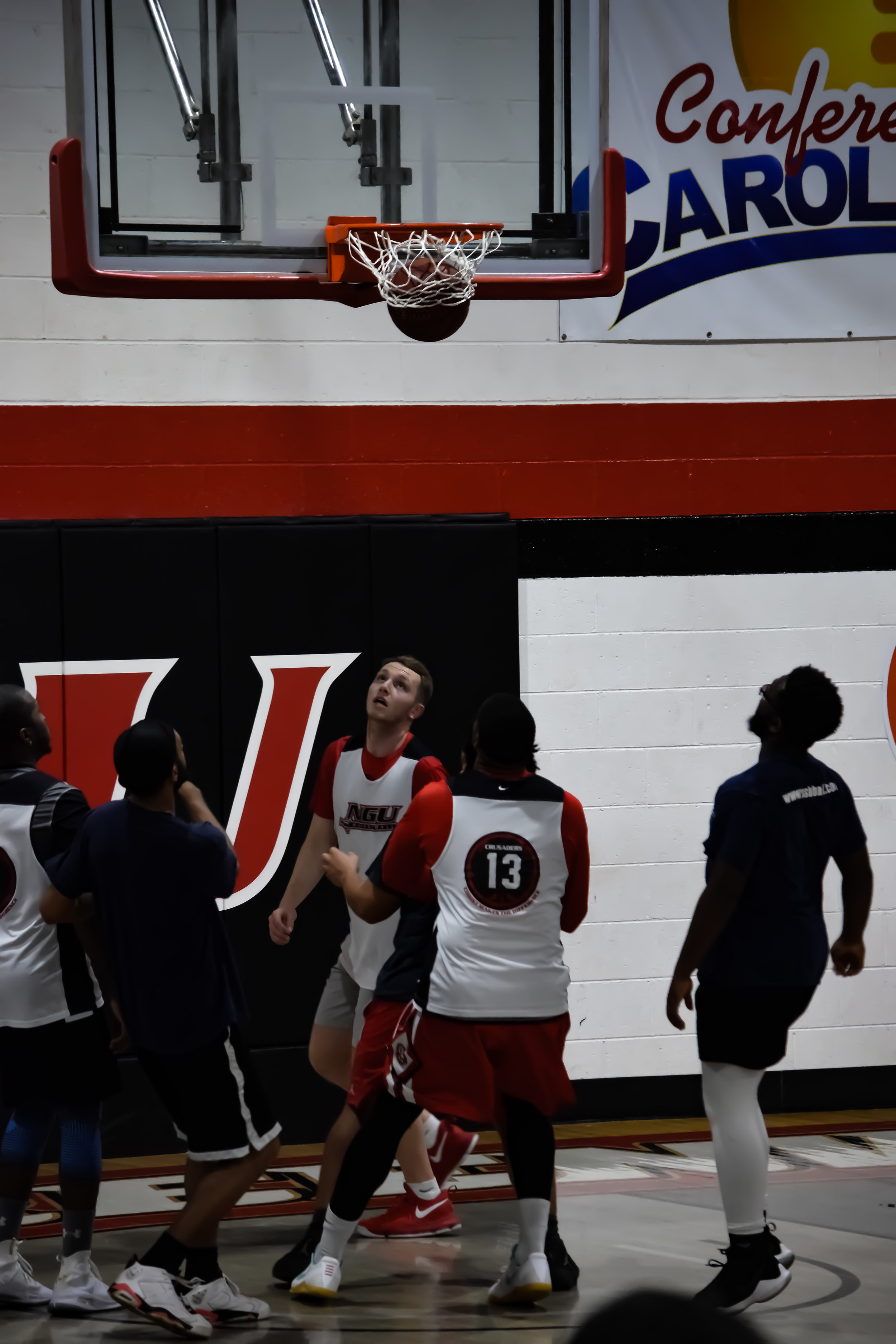 The "Longshot Magenta" and the "Old Men" go against each other in a wonderful round of basketball. The "Old Men" began with a huge lead against the "Longshot Magenta" with 32 against 12 in the first half.