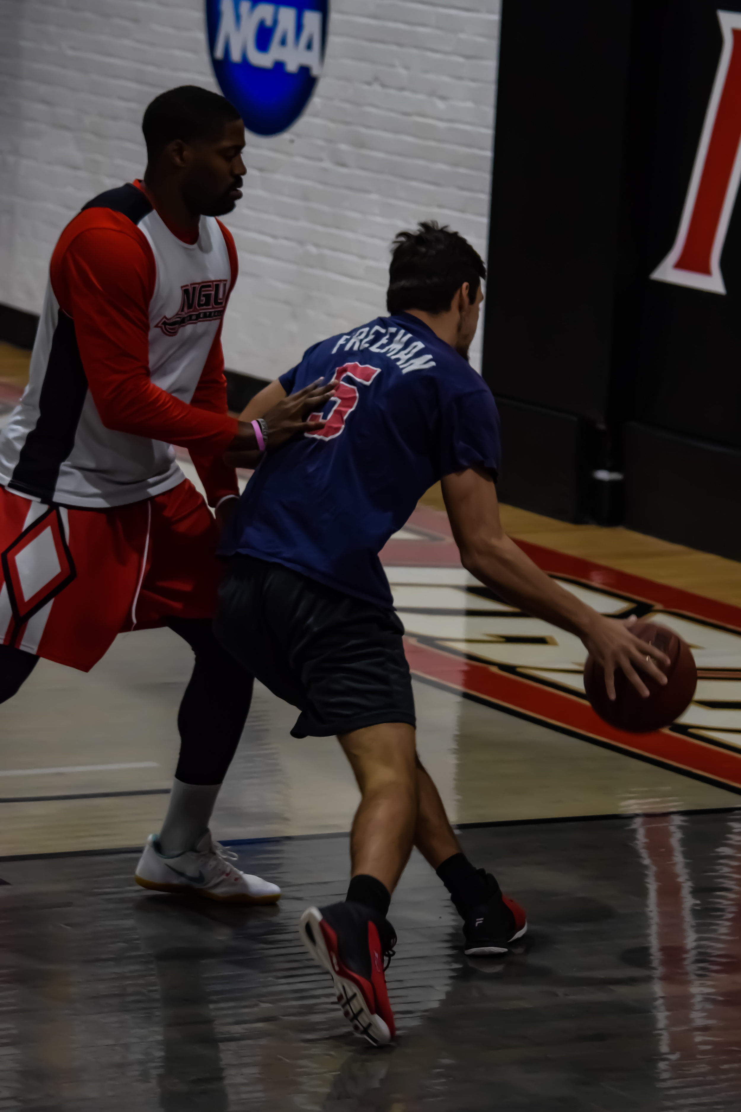 Matt Gravely makes his way down the court to make the shot and Jamaal Pryor tries to intercept.