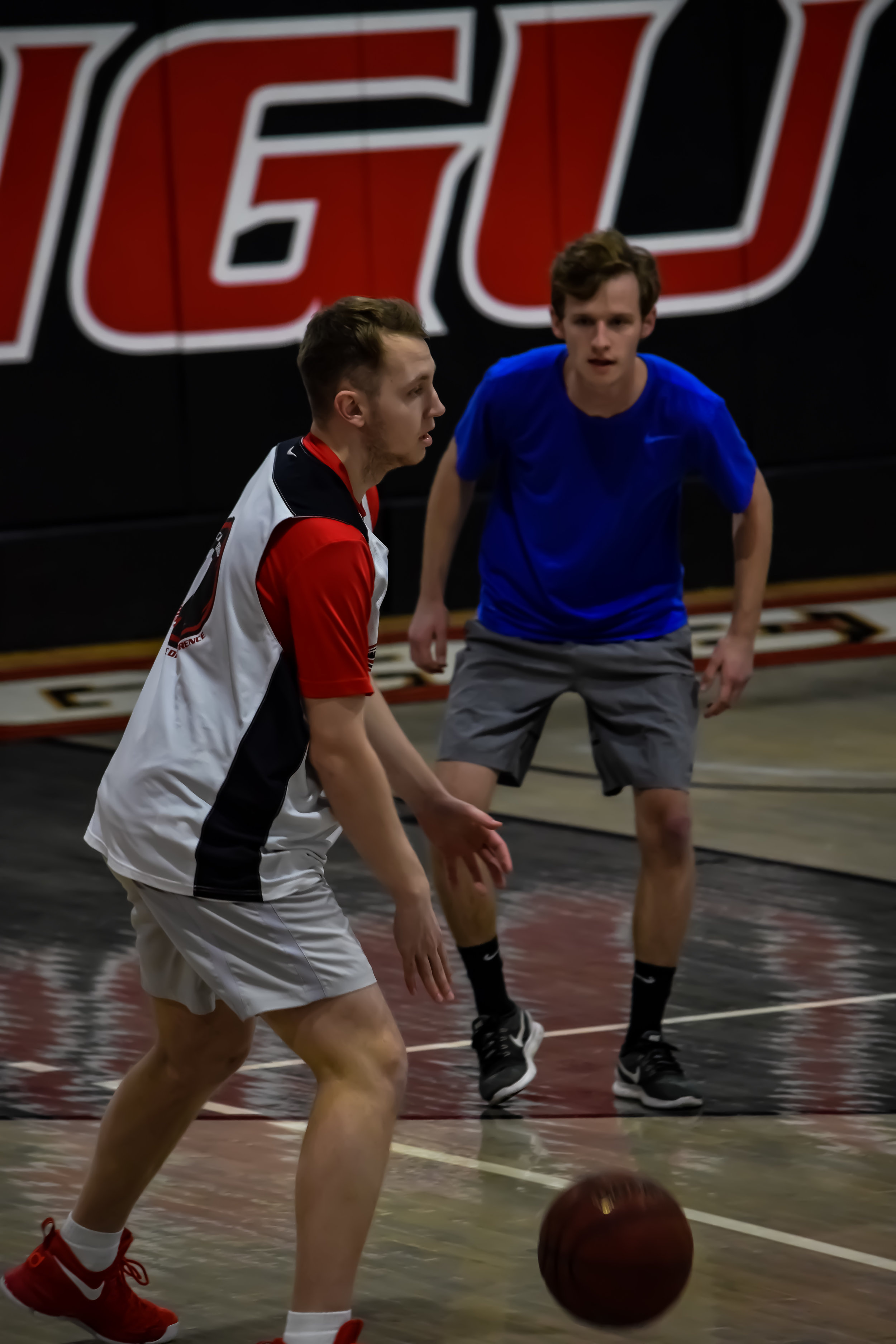 Sam Roberson and Walker Maasch face off at one end of the court.