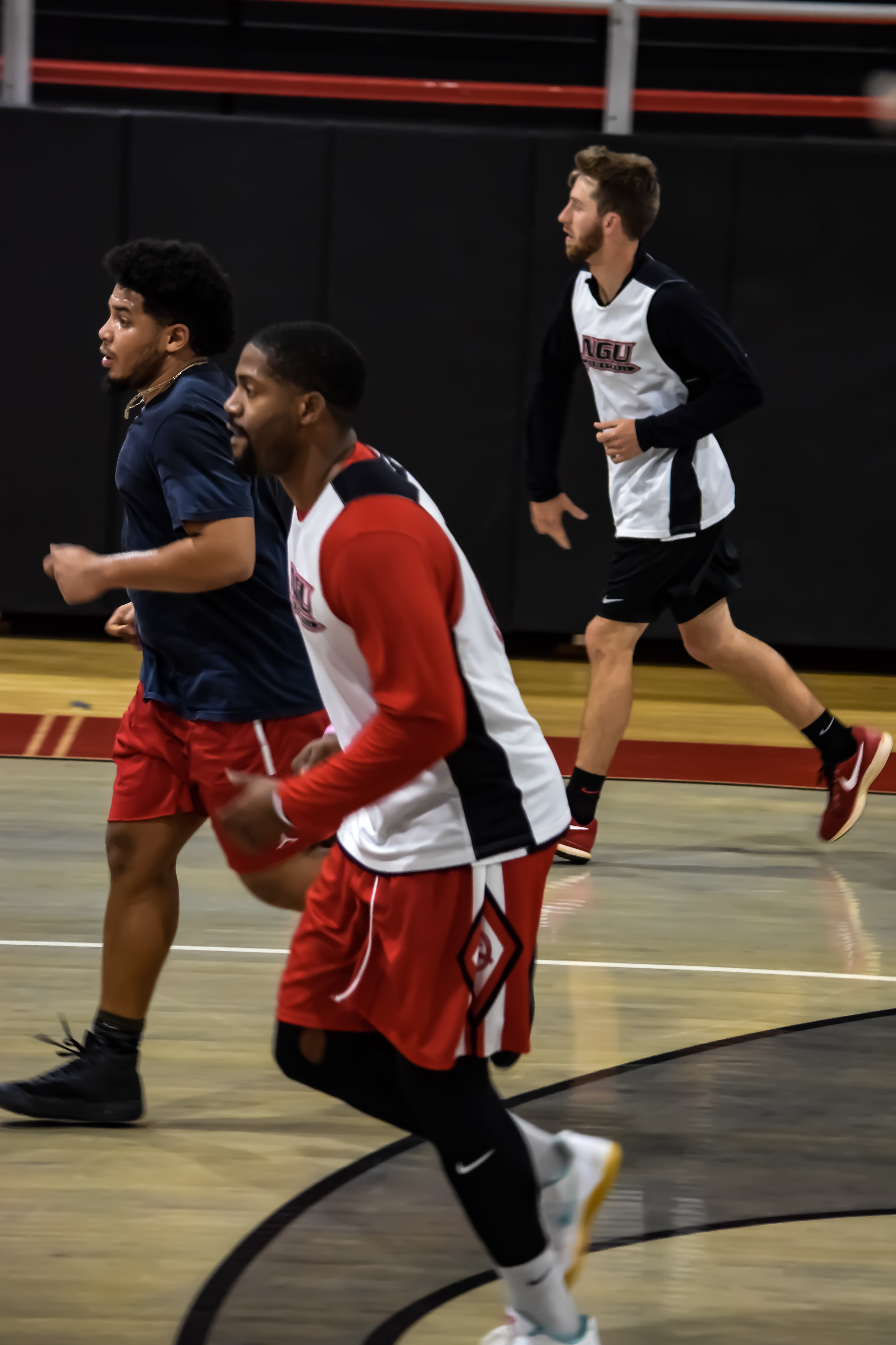 Jamaal Pryor, Bennette Hill, and Daniel Glaidous run down the court.&nbsp;