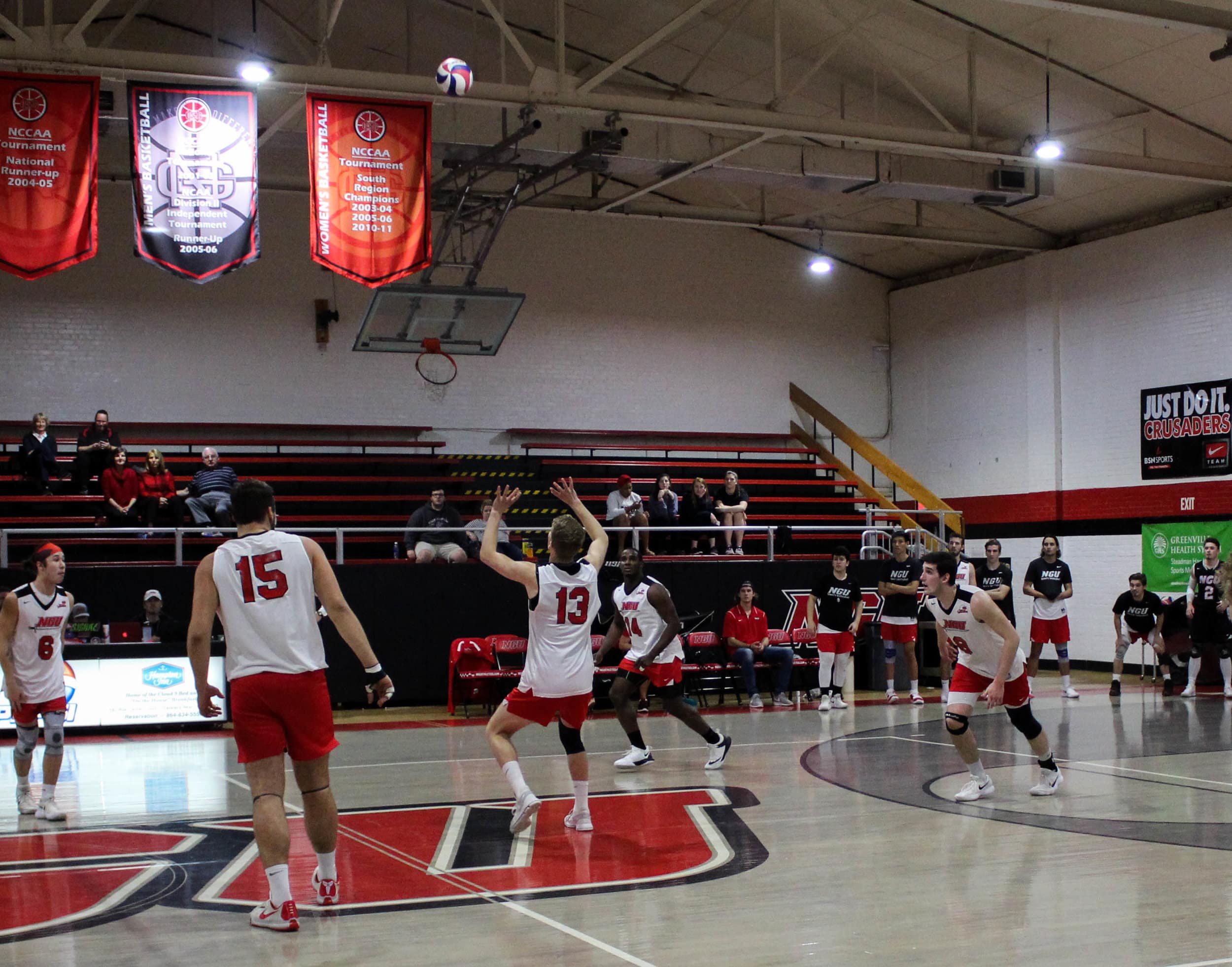 As the volleyball comes across the net, Ben Hamsho (13) gets ready to set the ball to his teammate.