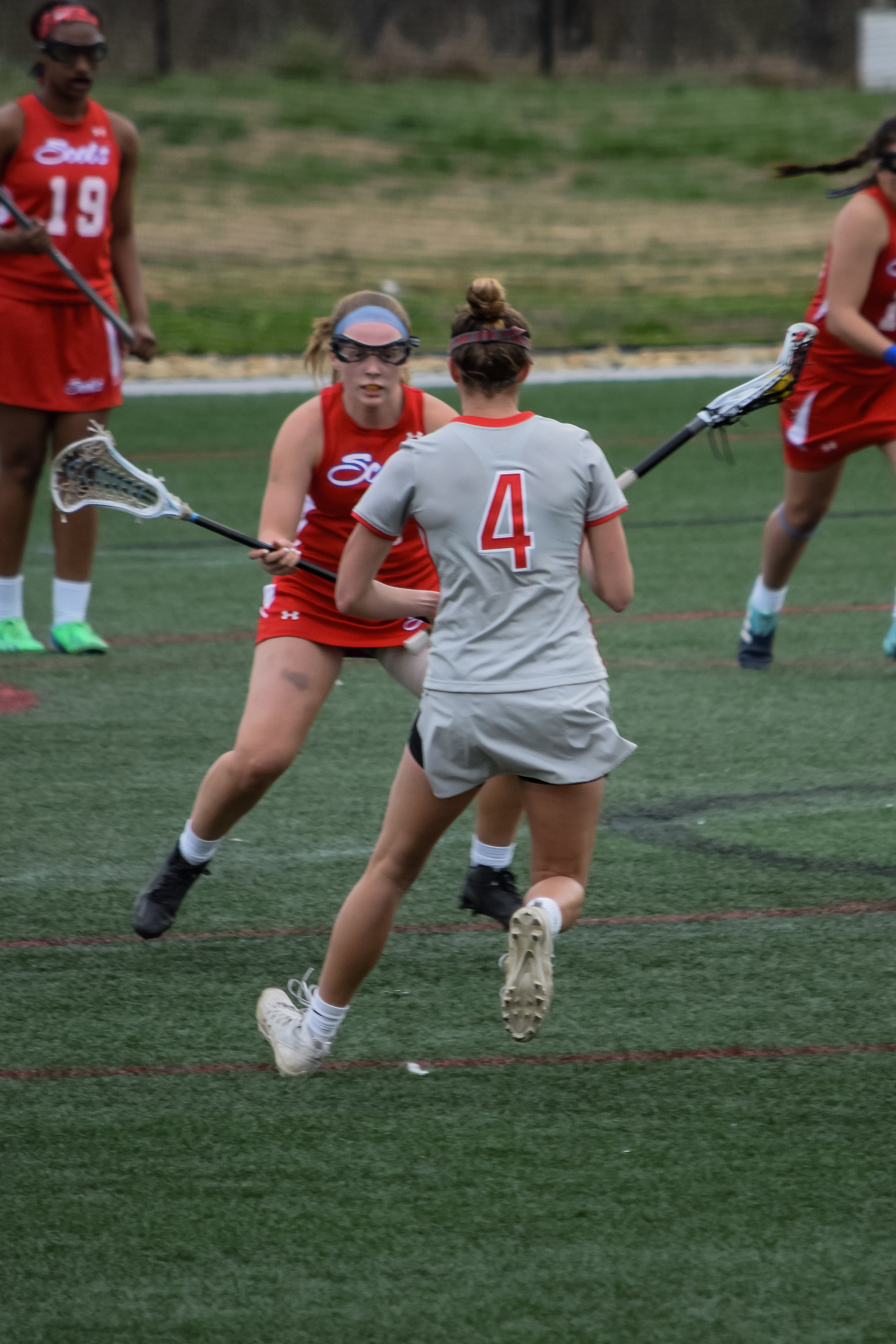 #4 Rachel Kellogg puts the brakes on as the opposing team gets ready to knock the ball out of her possession.