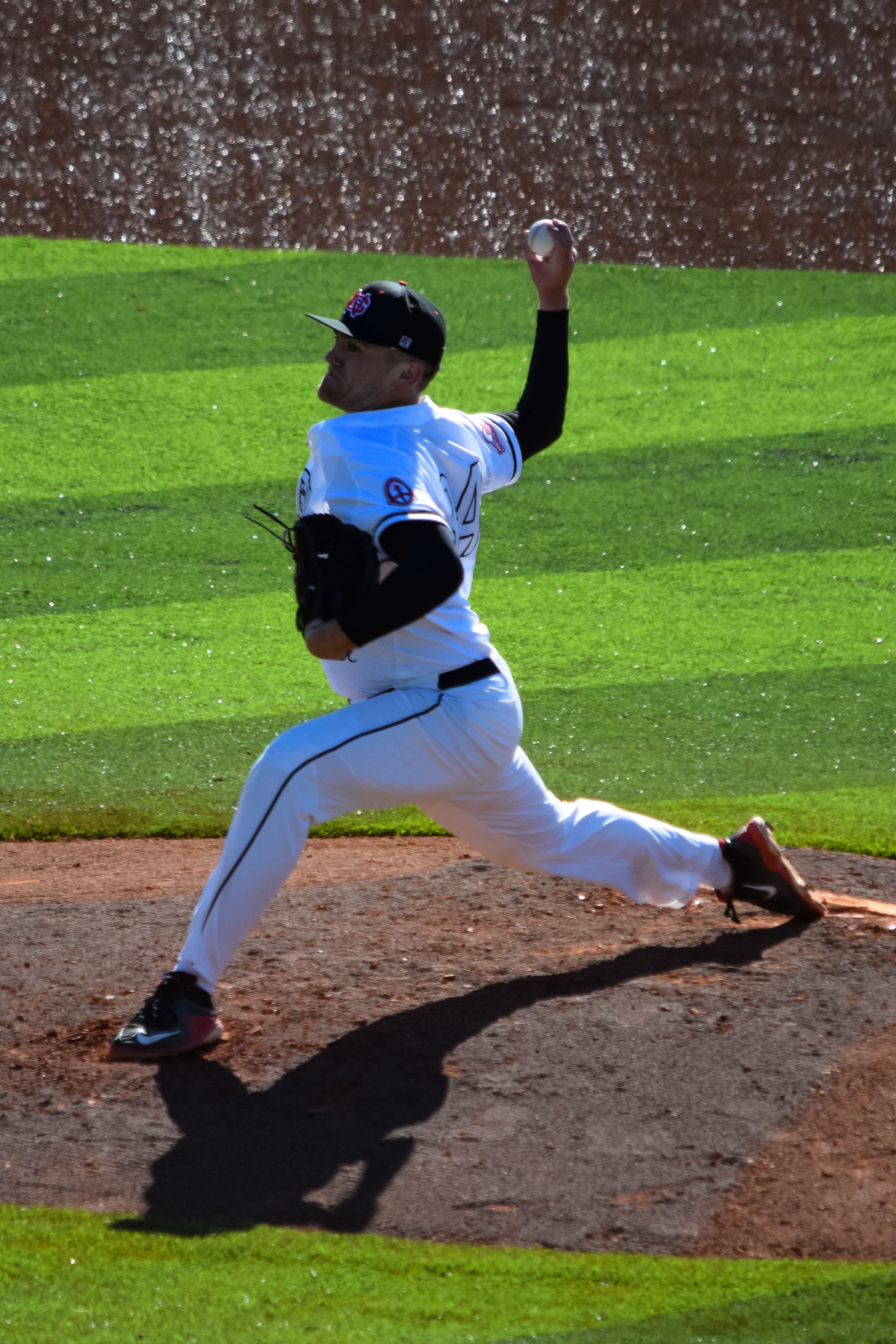 Pitcher #34 Jared Lembcke shows off his impressive form as he begins to send the ball straight to home plate.