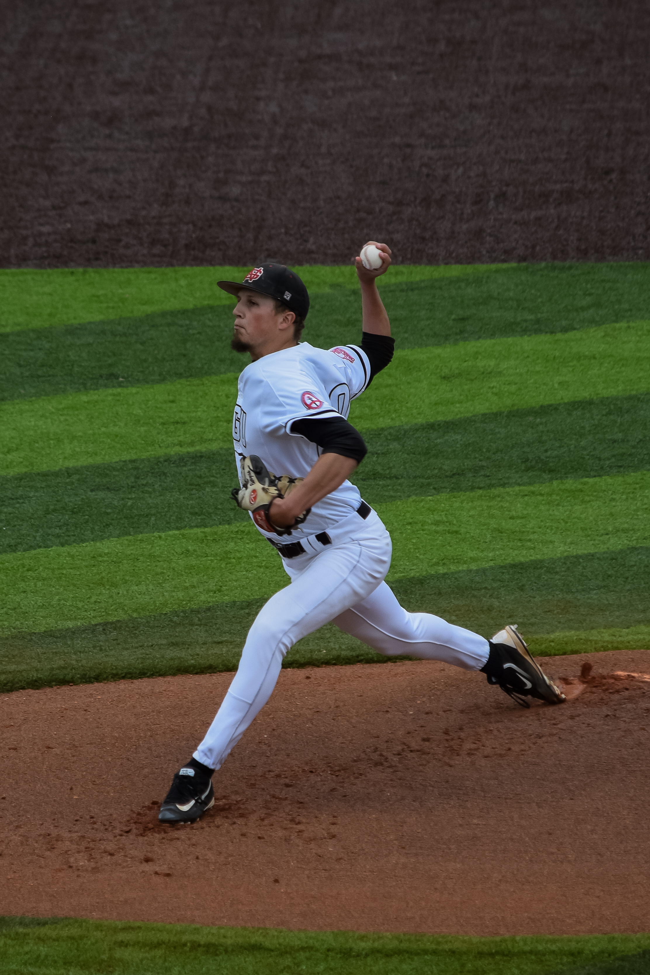 Pitcher Tucker Burgess shows off his strength as he winds back to send the ball flying to home plate.