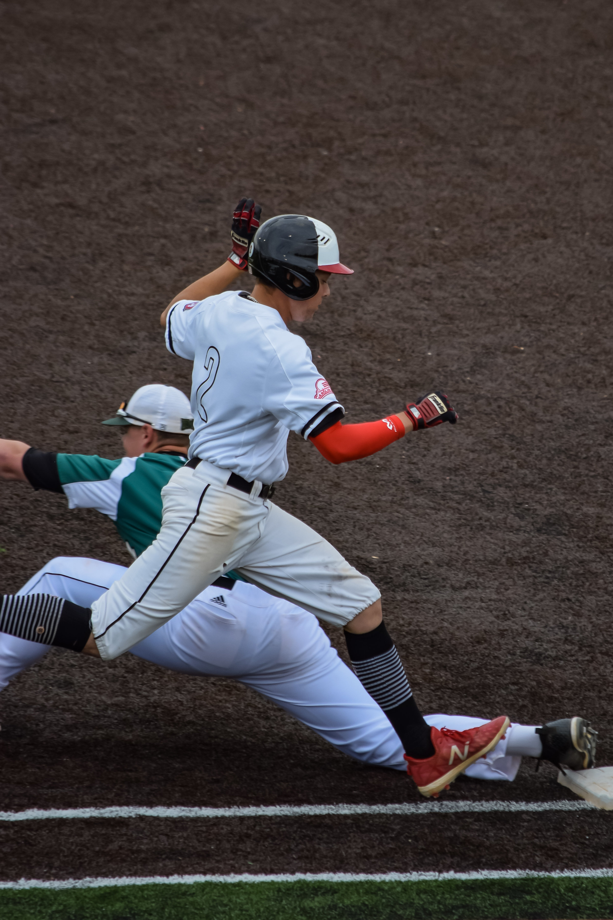 Utah Jones rushes to beat the ball to first plate, but ends up being a bit late.