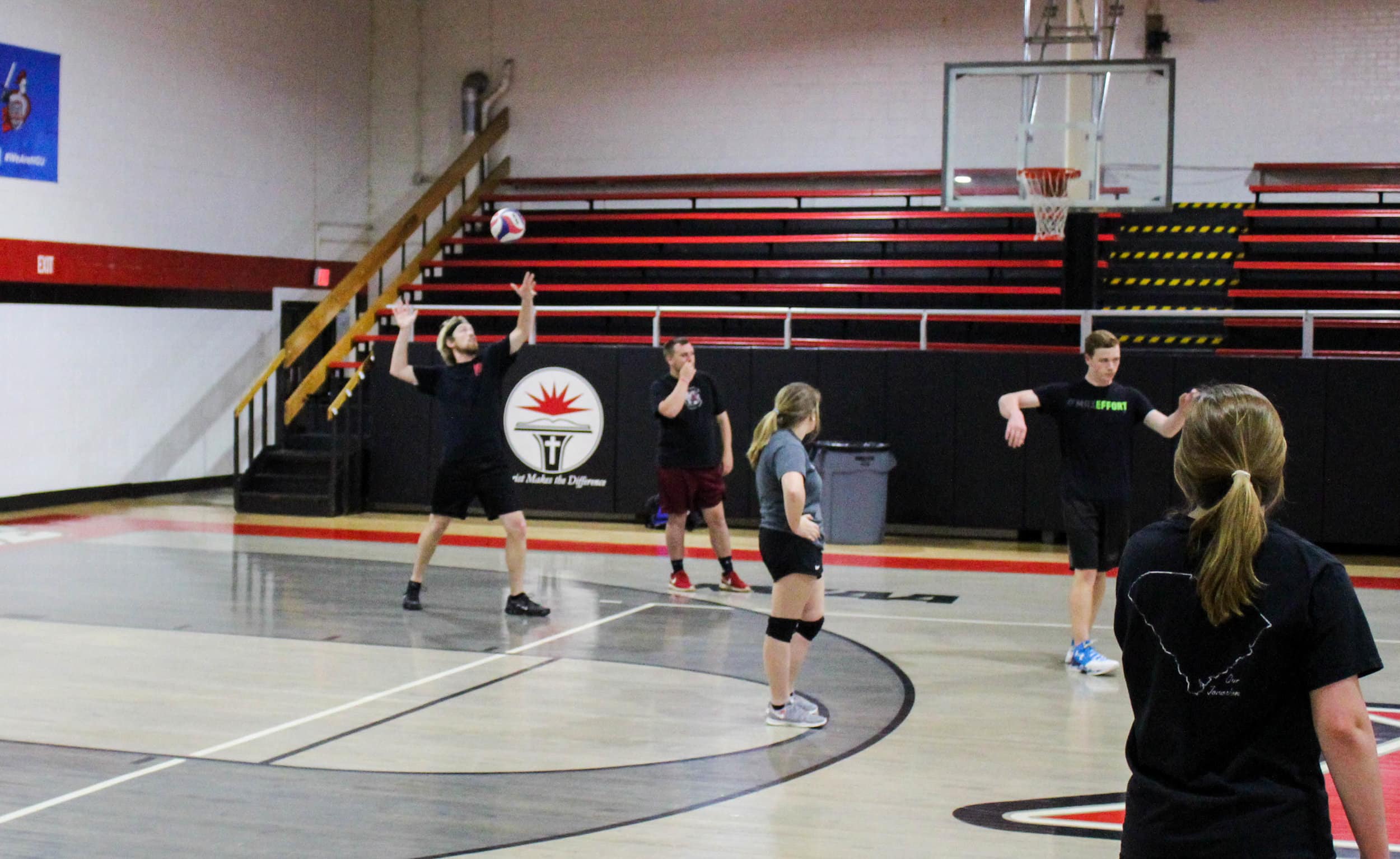 Zach Clark tosses the ball as he gets ready to serve it over the net.