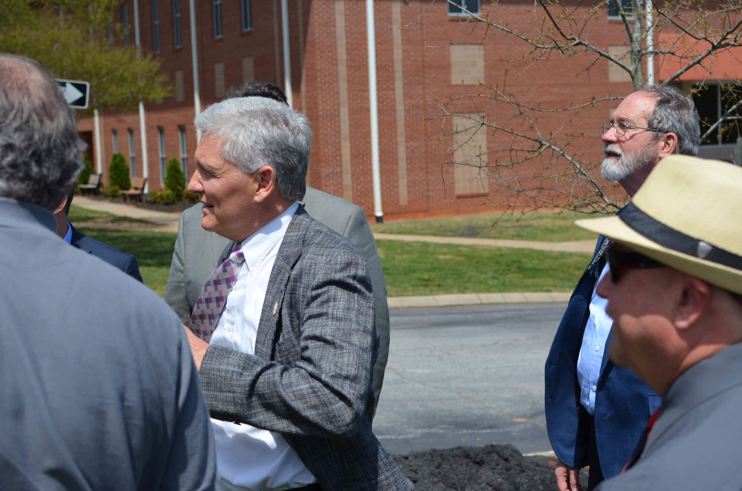 Professor Curtis Horn converses with colleagues after plantation.&nbsp;