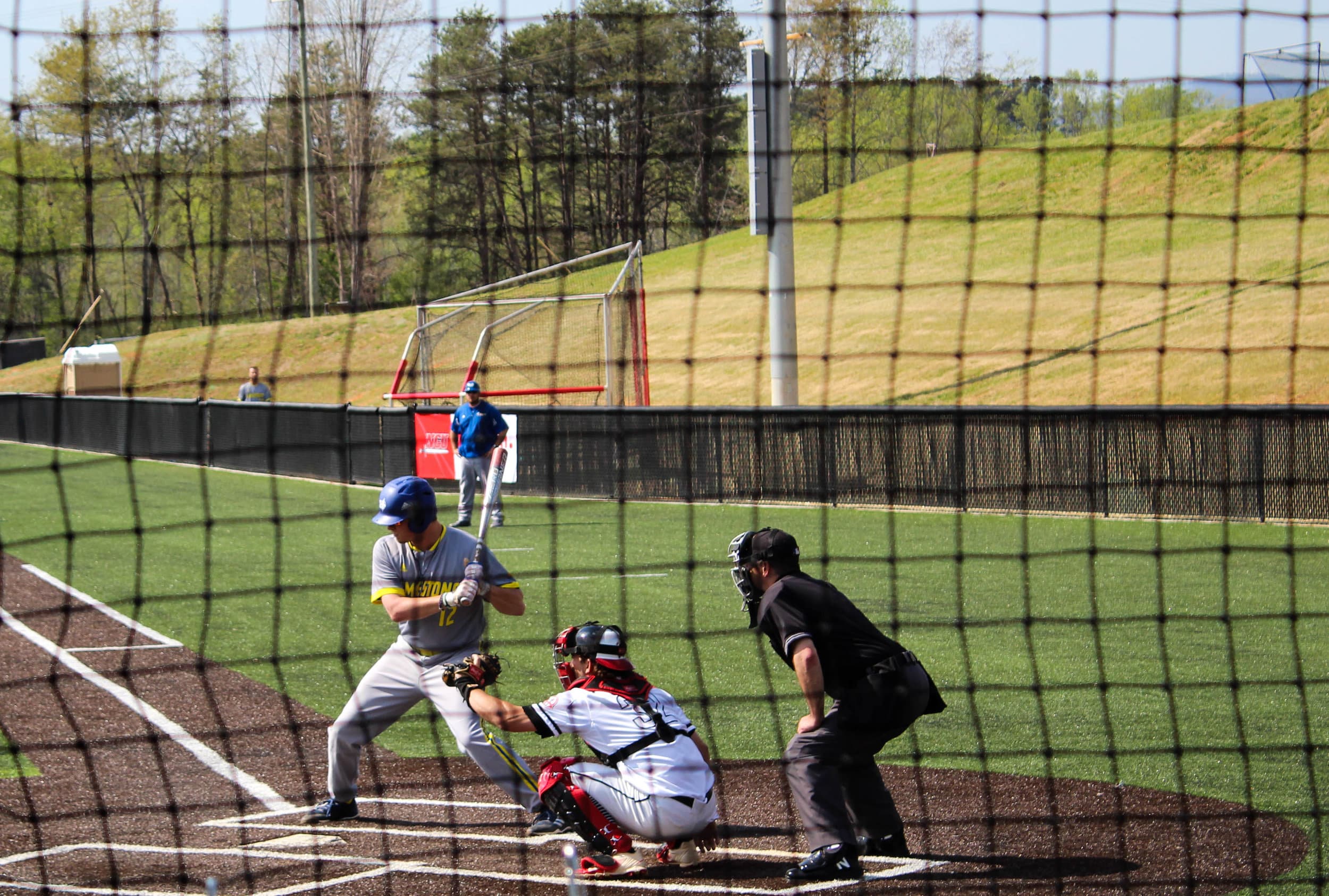 John Jones catches the ball pitched to the batter.