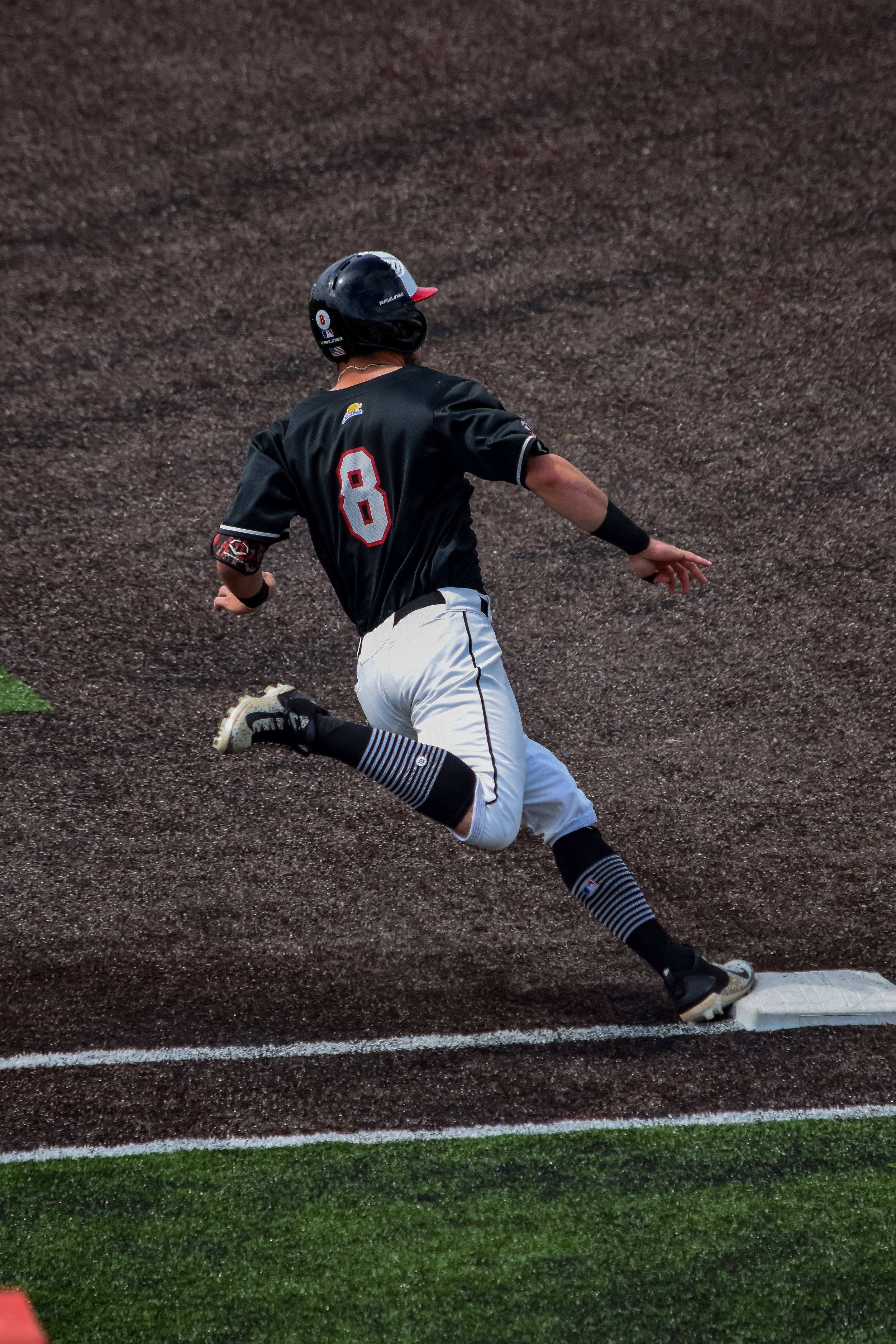 Josh Black makes his way around the bases as he looks to see if his pop fly gets caught.