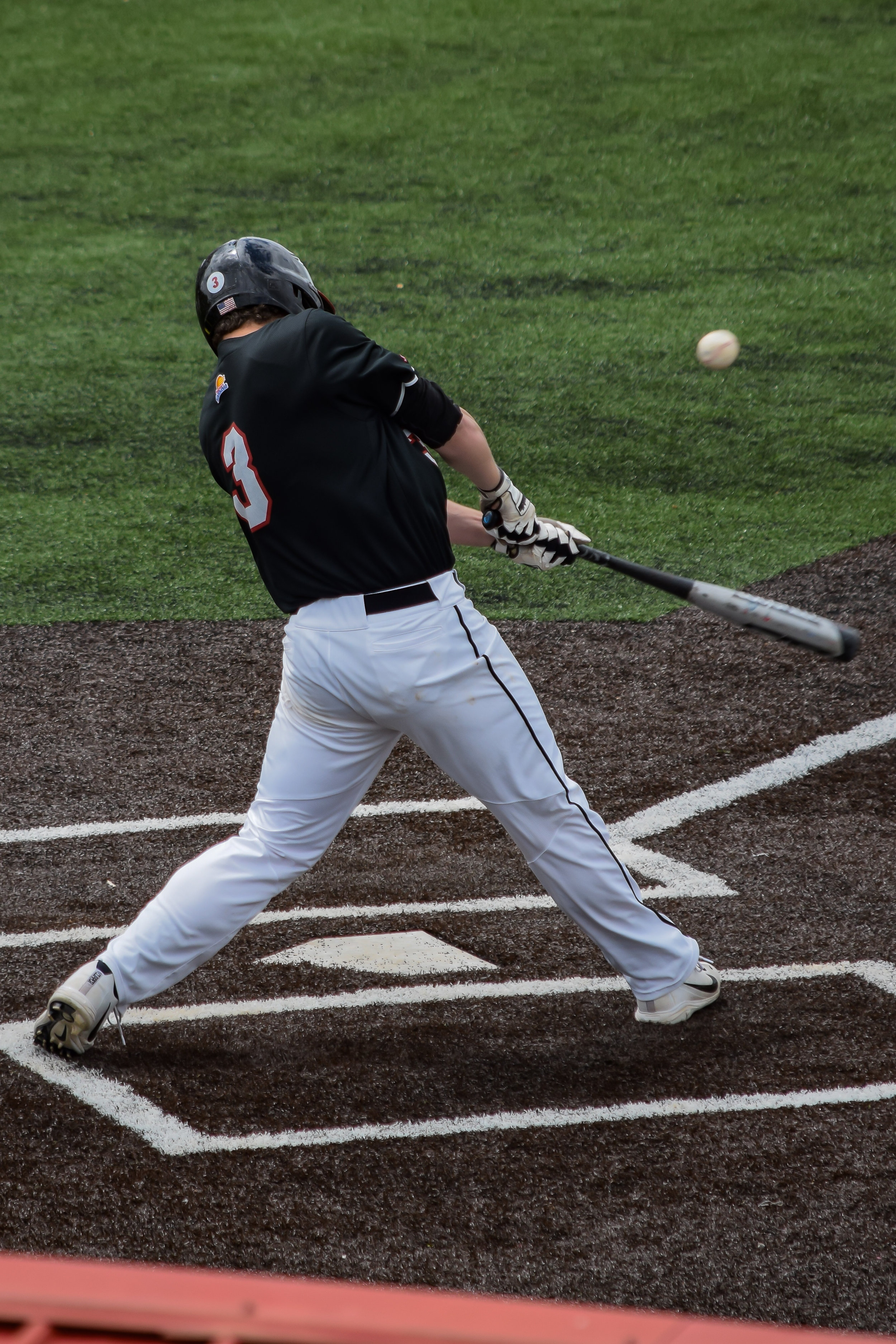 Brown shows off his skills as a batter as he sends the ball flying towards the outfield.