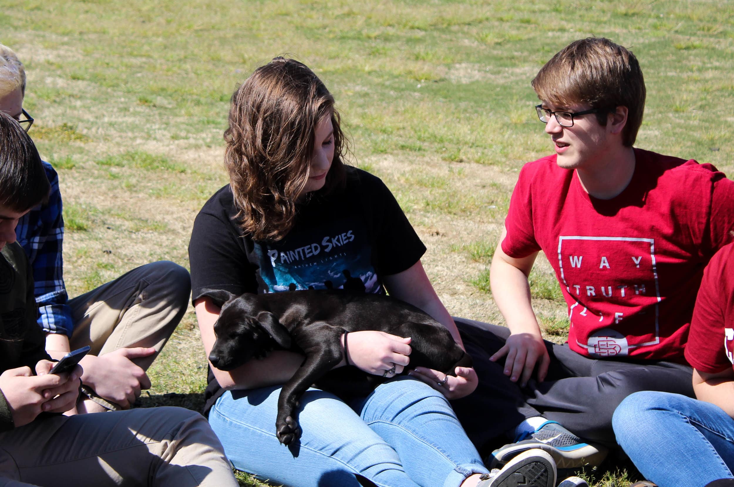 Freshman Naomi Schaaf holds a puppy as it takes a nap.