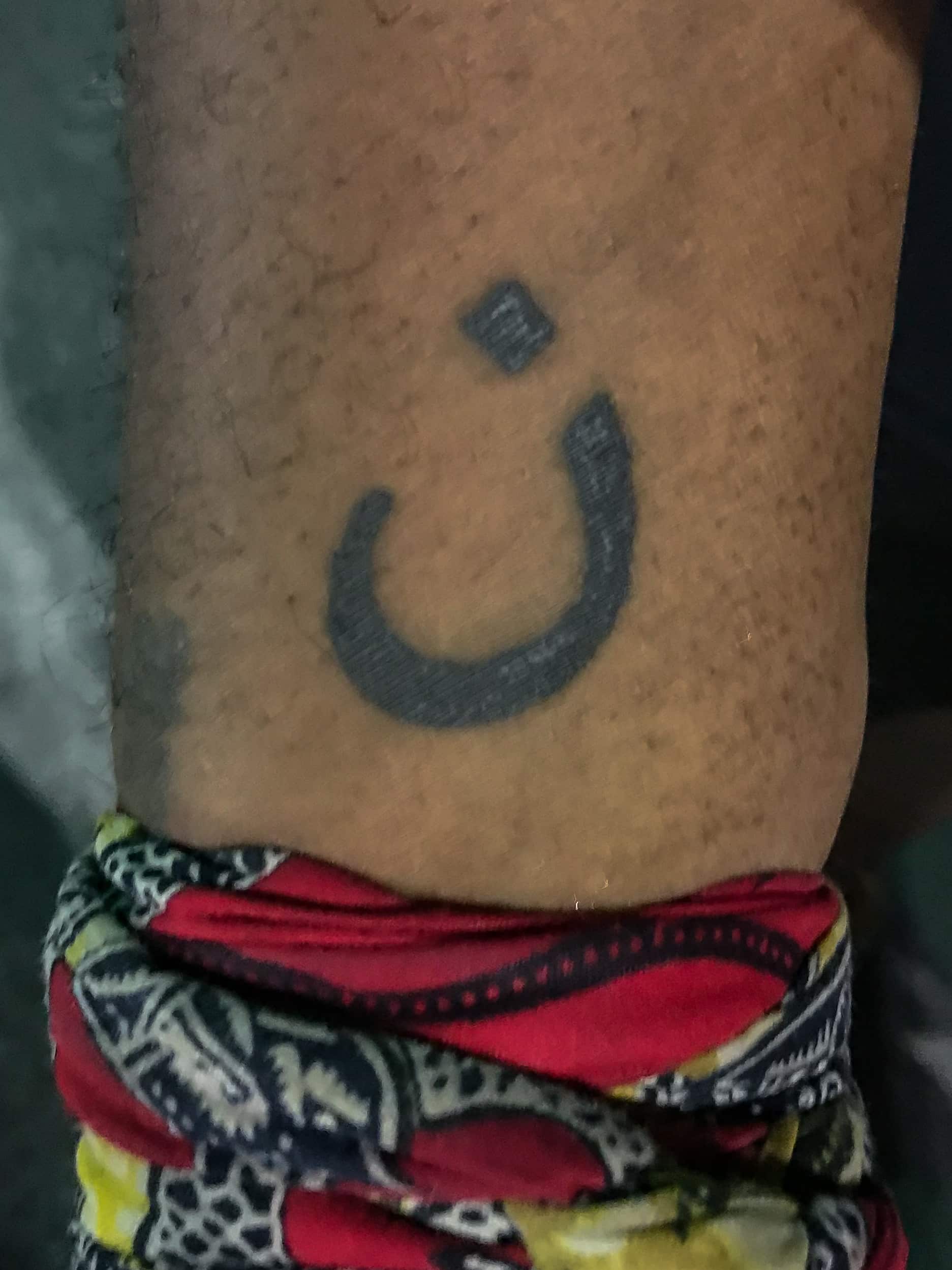 This is Mykel Perdue. This tattoo is the Arabic symbol for the letter N. It is to represent the Israelites crucified a Nazarene and Perdue relates to and is a brother of all persecuted Christians around the world.