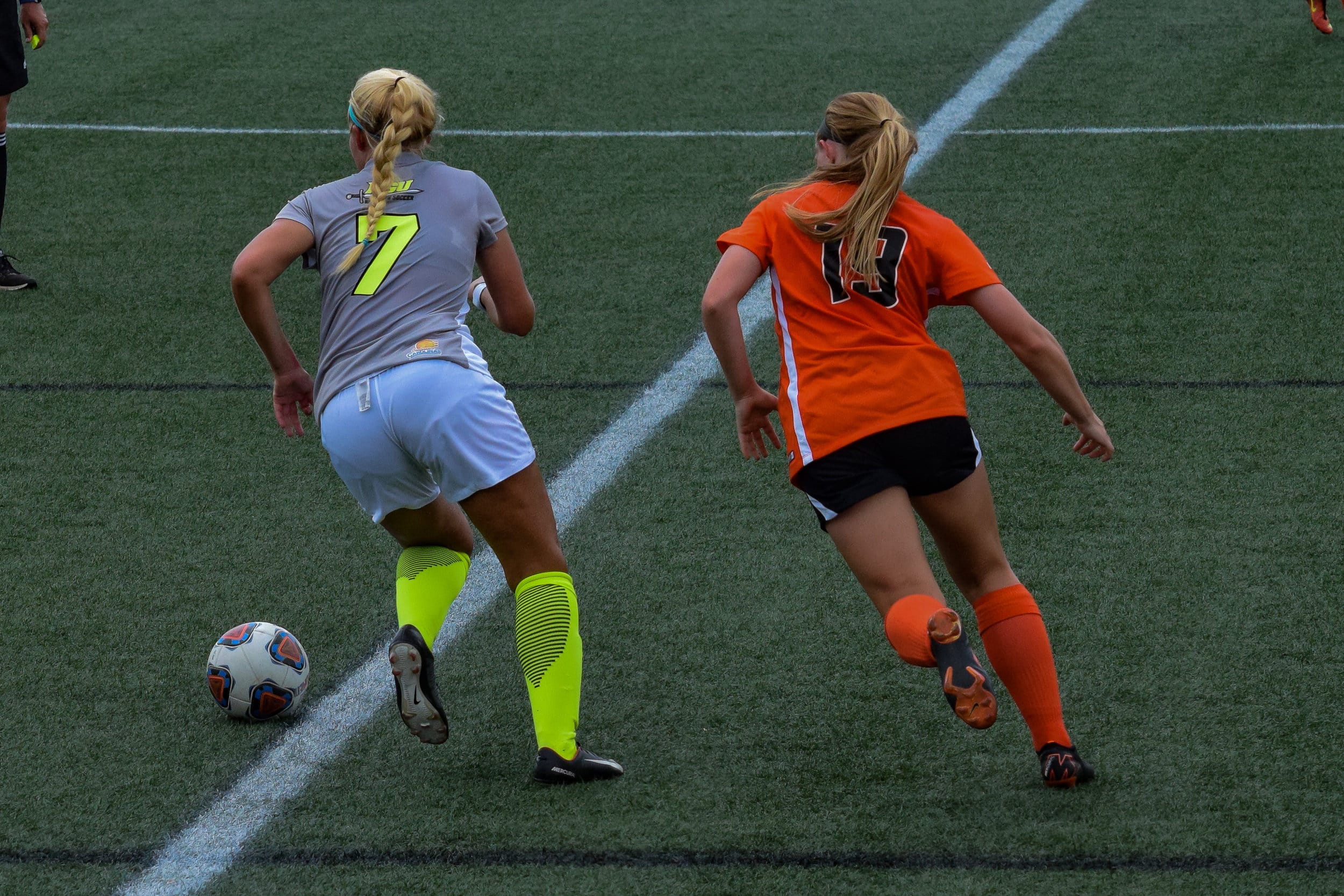 #7 Abby Robinson begins to run the ball back to the opposite side of the field to attempt to make a goal.