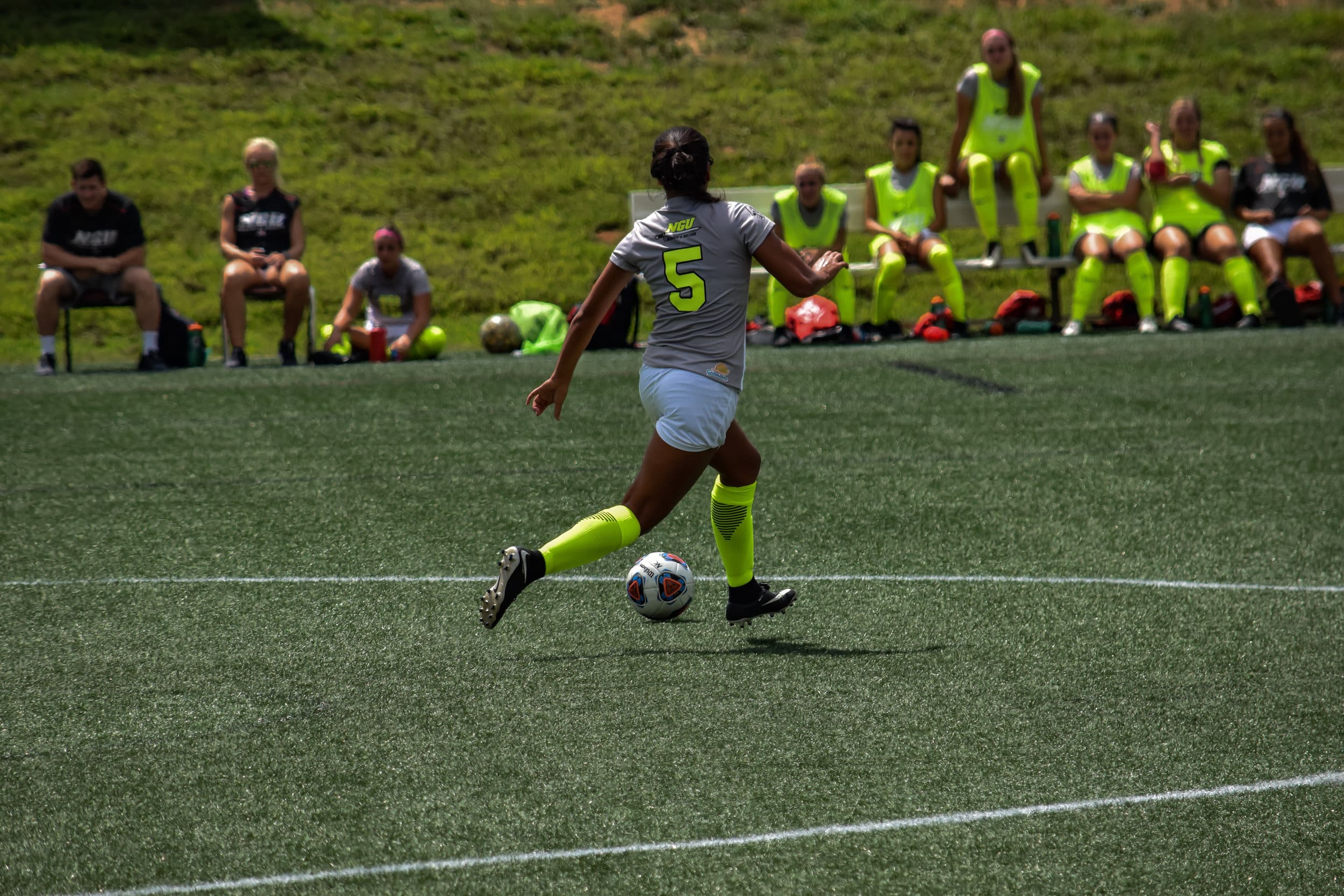 #5 Joelle Chick prepares to plant her foot in order to kick the ball to another teammate.