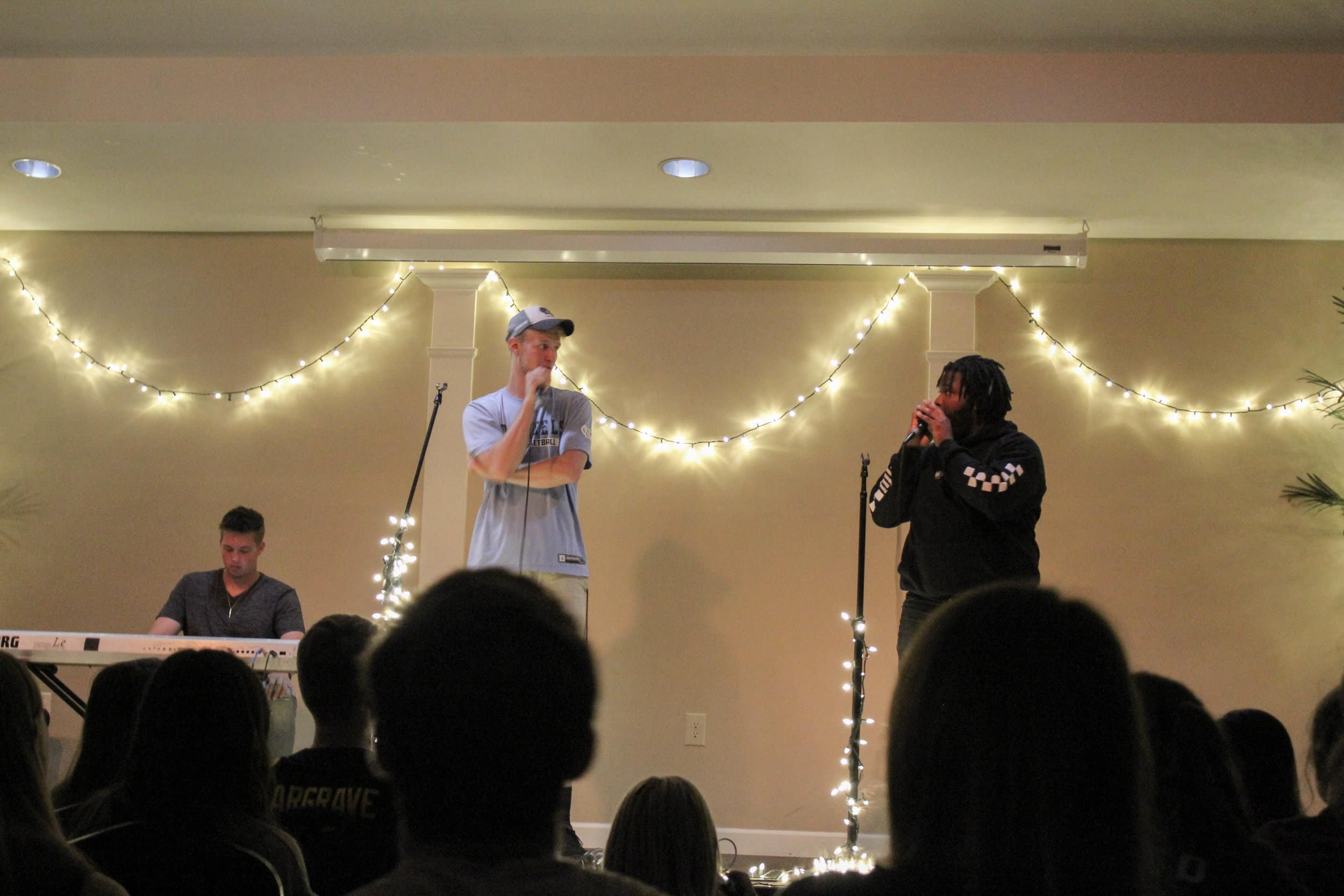 Juniors, Ben Hamsho and Mykel Scott talk to the crowd about the Crusader football team. They discussed how the football team moved to the Gulf South Conference and urged students to attend the first home game the following week to show support.