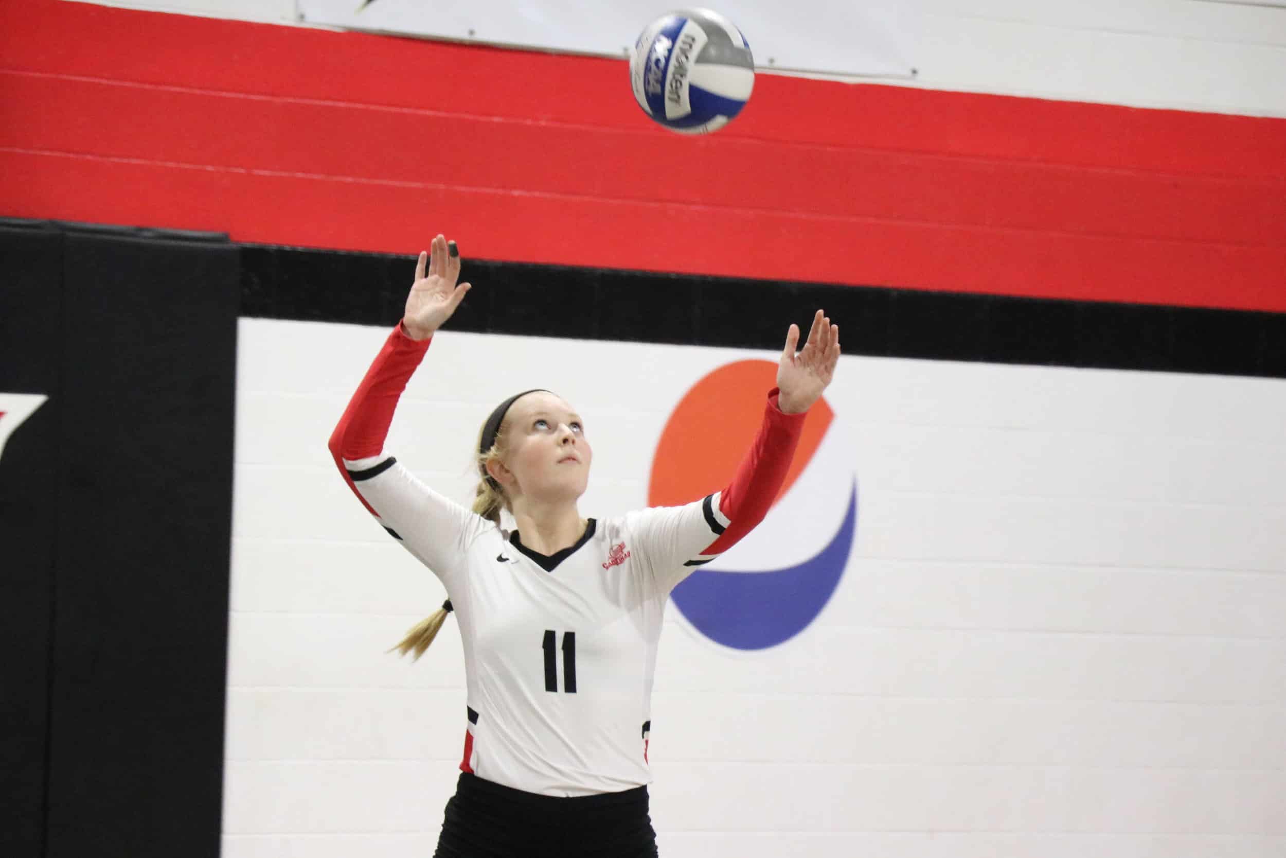 Junior, Madison Curtis serves the ball to the other team.