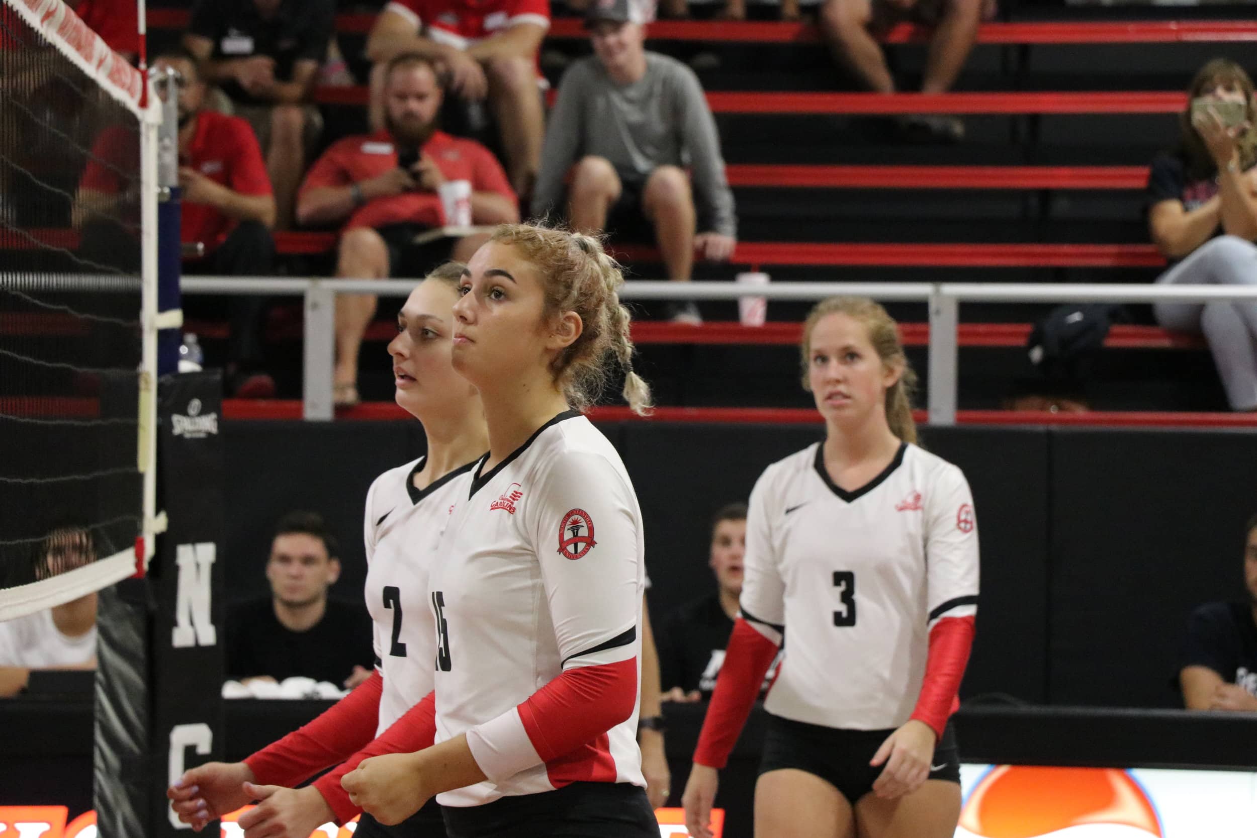 Sophomore, Katie McManaway (15), freshman Paige Beisecker (2) and junior, Emma Pepper (3) are anticipating their next move.