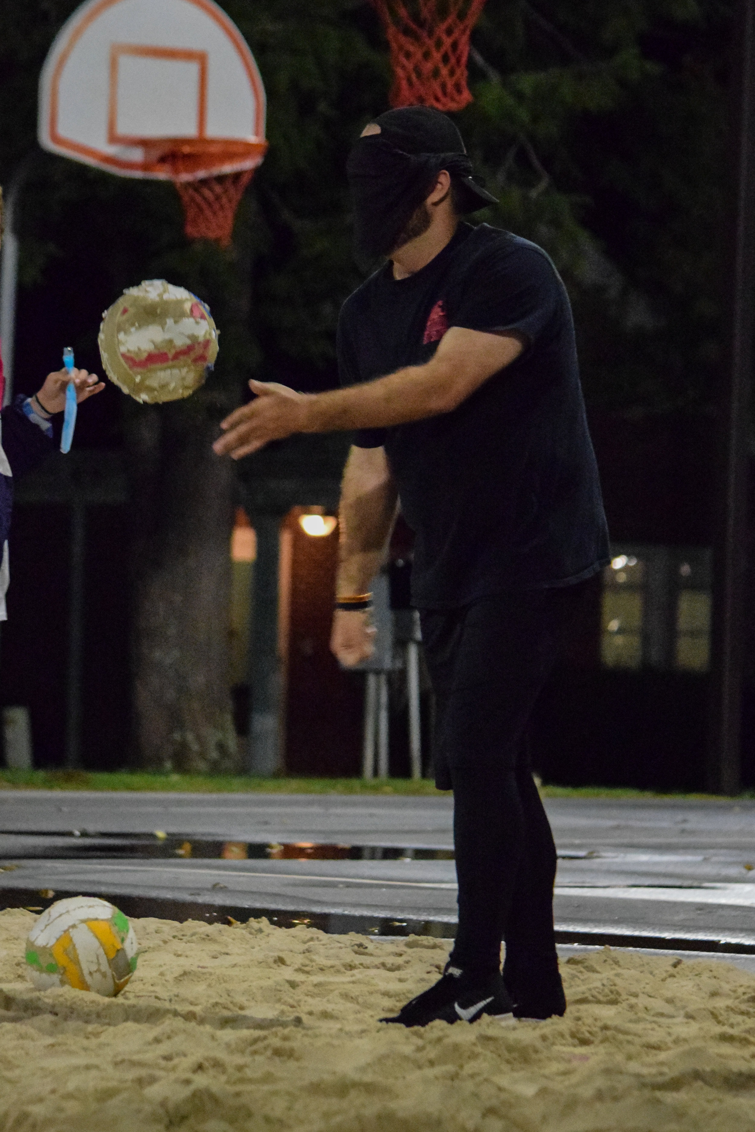 Criminal justice club member Cory Williams, senior, sends a volleyball soaring over the net while blindfolded in order to advance is club to the next obstacle.