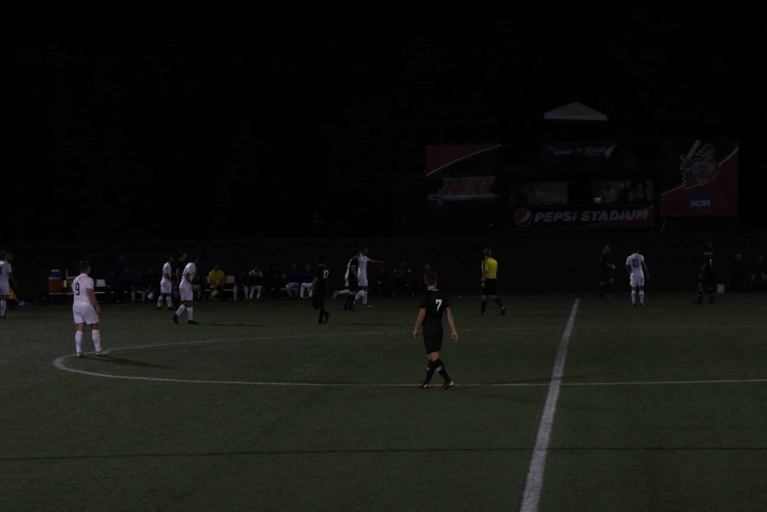 The players stay focused as they wait for the game to resume.