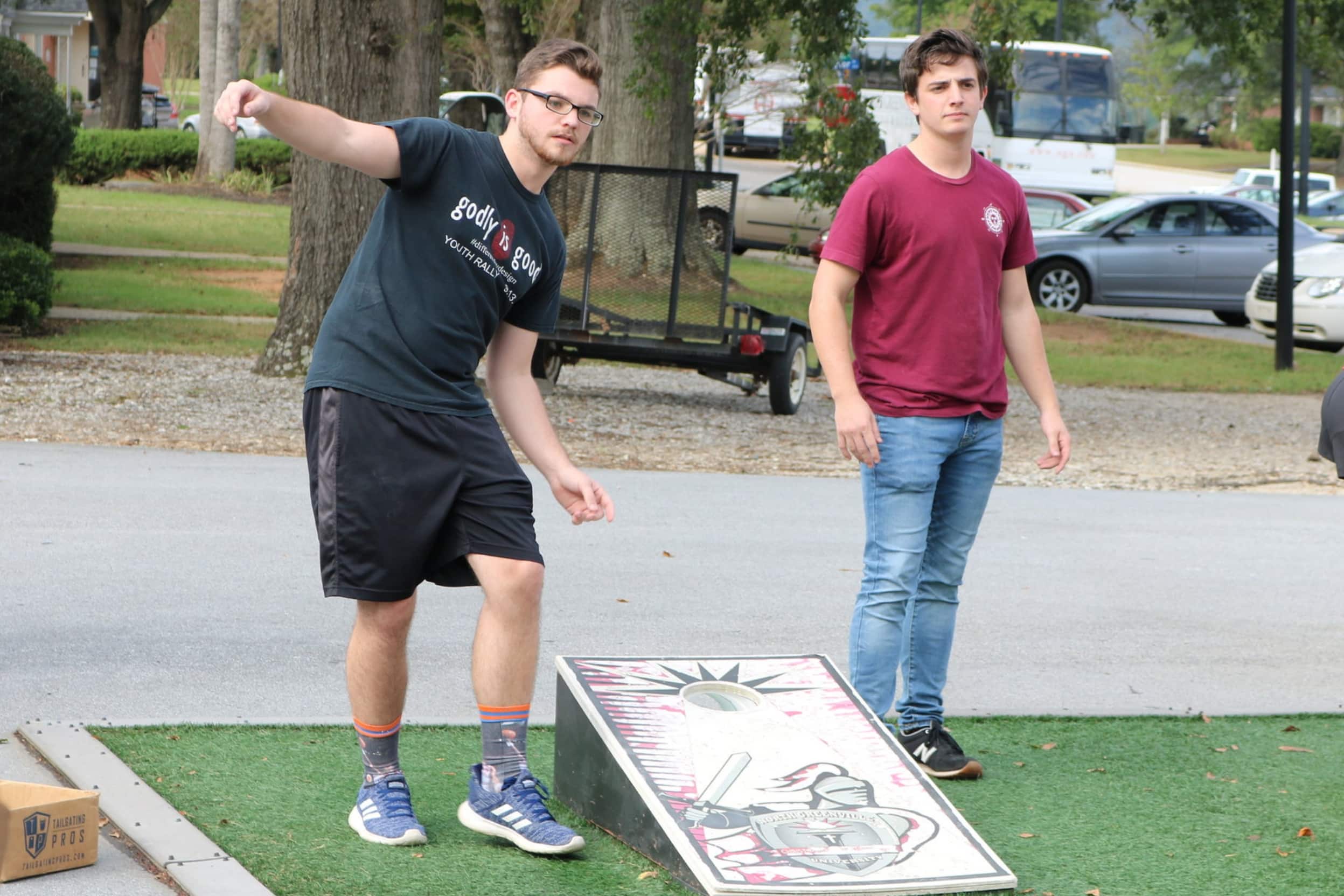 Junior, Jonny Hannah and senior, Jon Andrews are focusing in on winning for their clubs when playing in the Corn-Hole Tournament Tuesday afternoon.