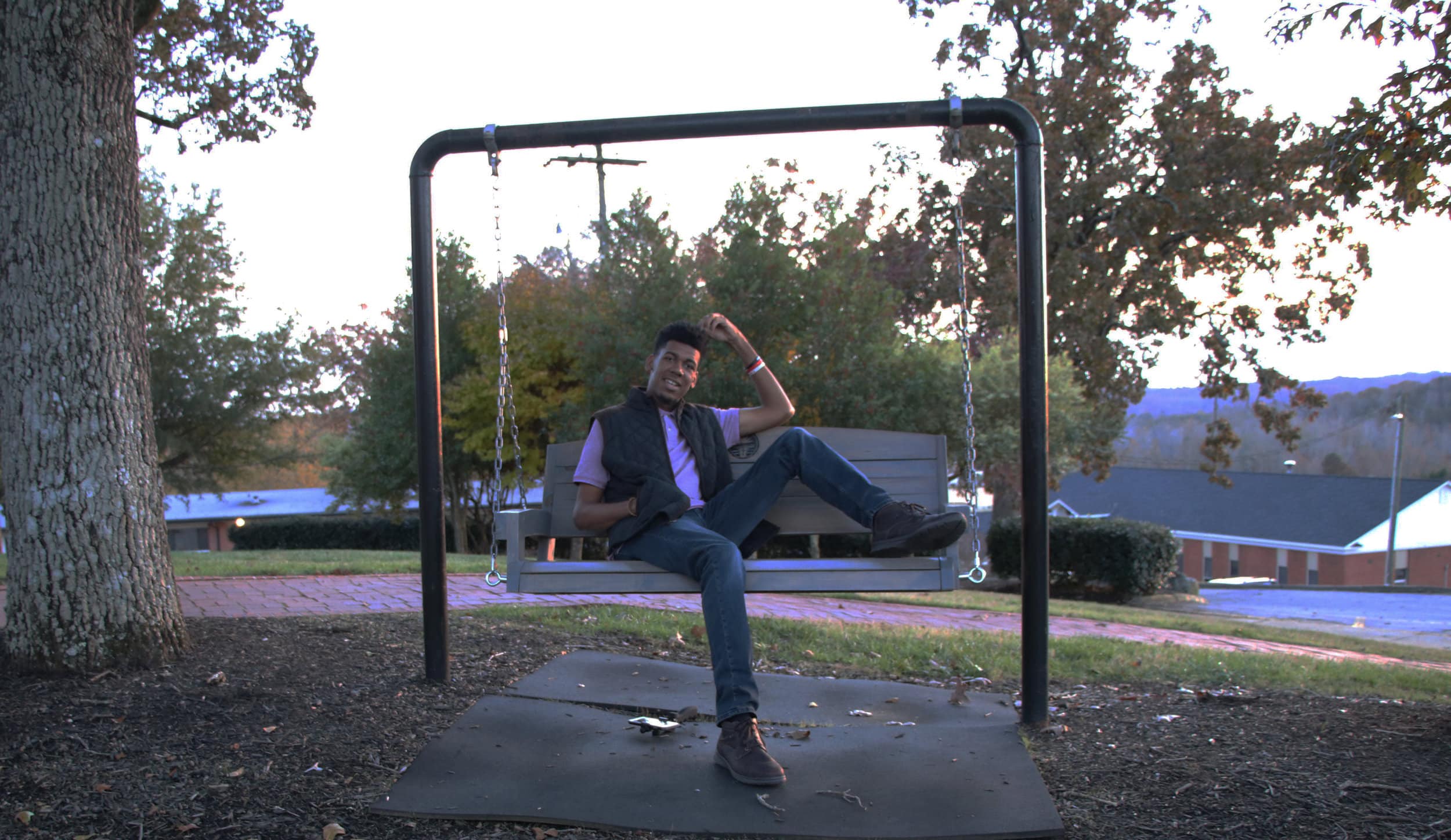 Zion Dendy, sophomore, throws on a vest over a light tee shirt and wears dark brown boots.