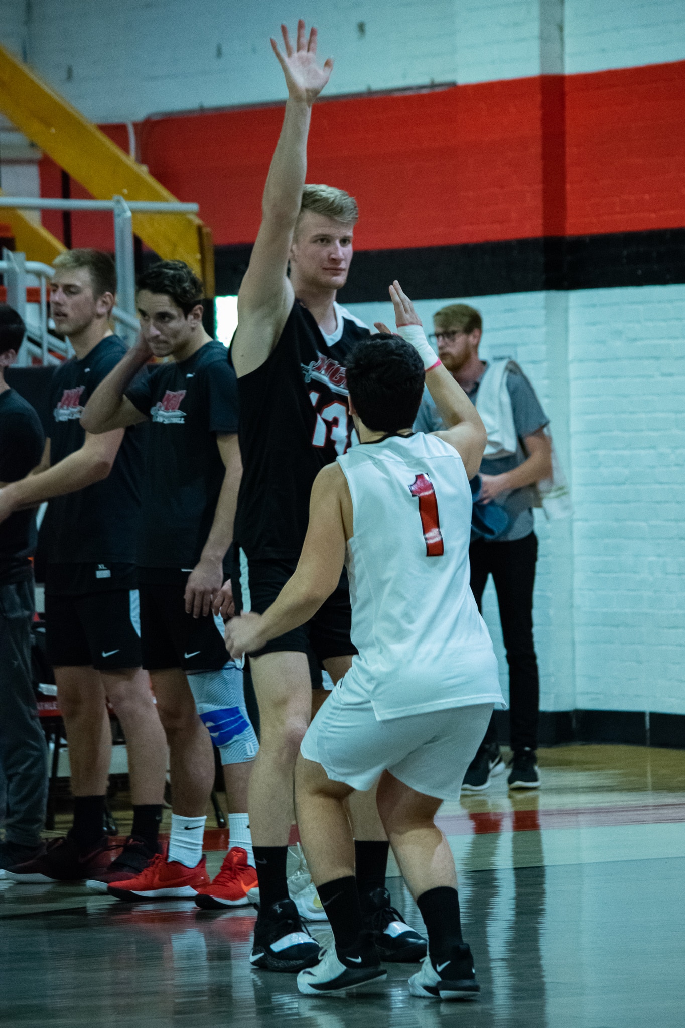 As sophomore Arlind Rojba (1) greets each player after being introduced, junior Ben Hamsho (13) lifts his arm to show off his height compared to Rojba.